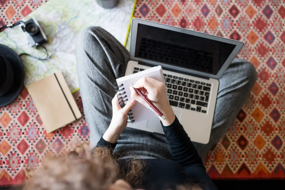 Girl planning a trip with her laptop