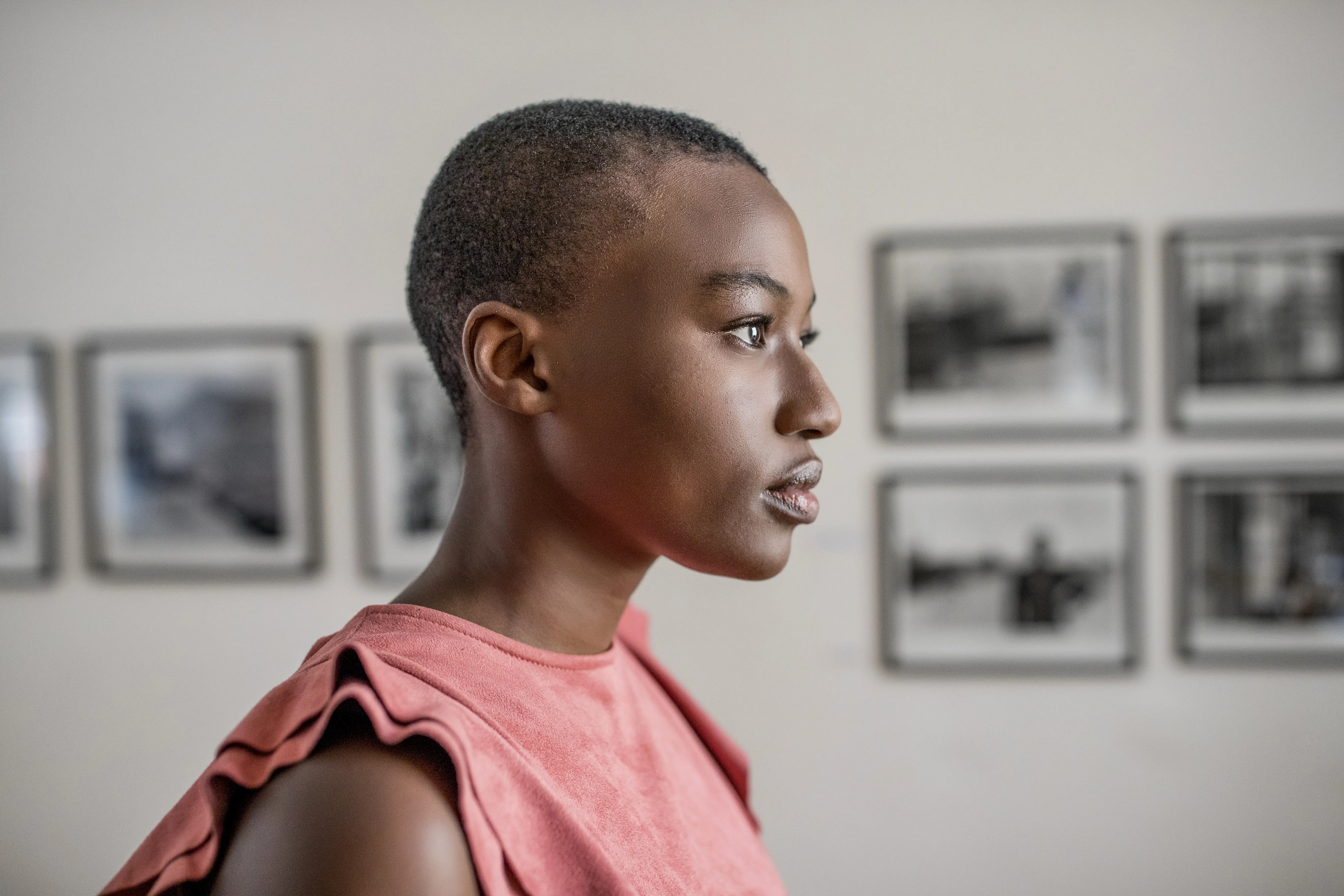 Image of a woman observing works in a gallery.