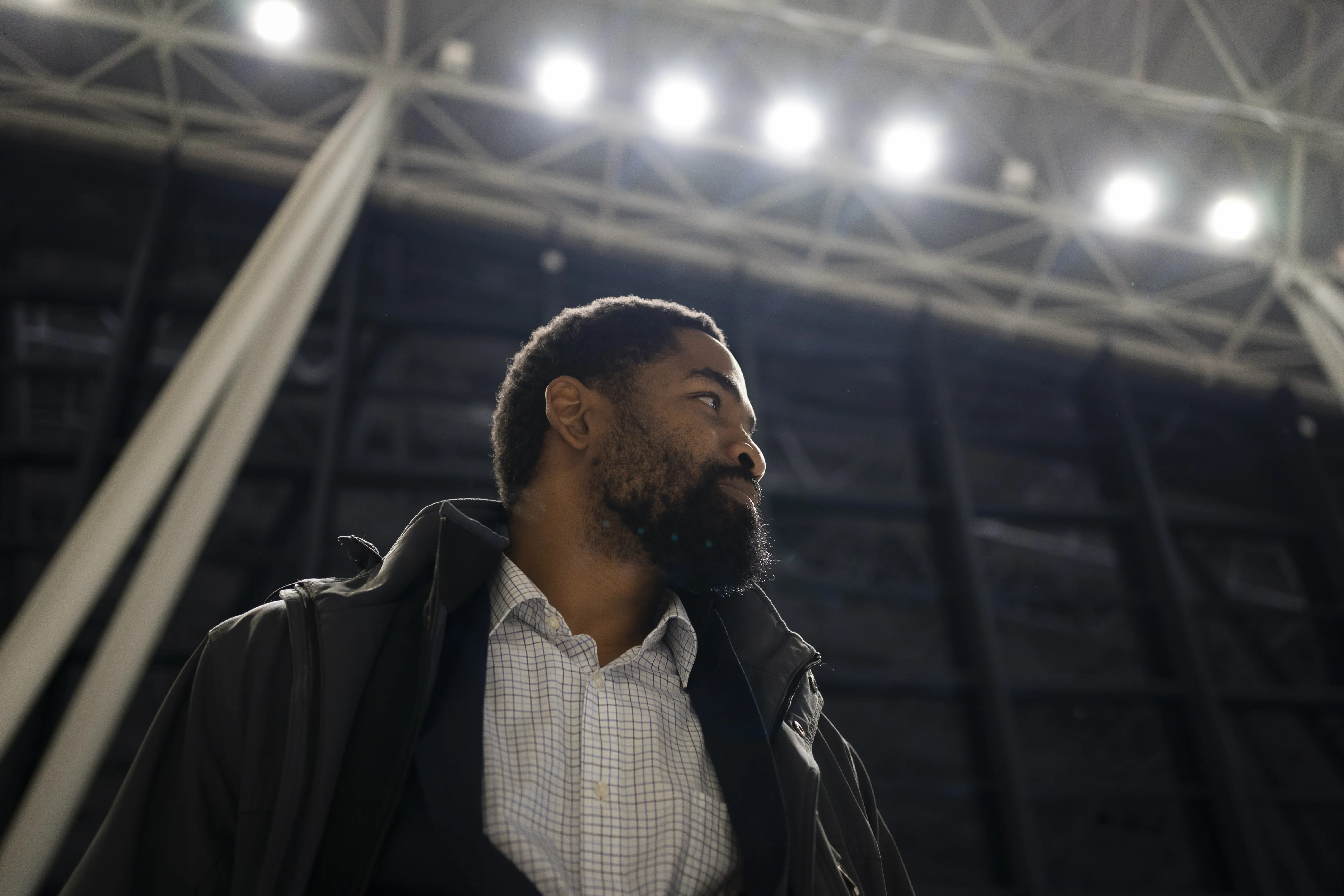 Image of a man standing in an indoor stadium.