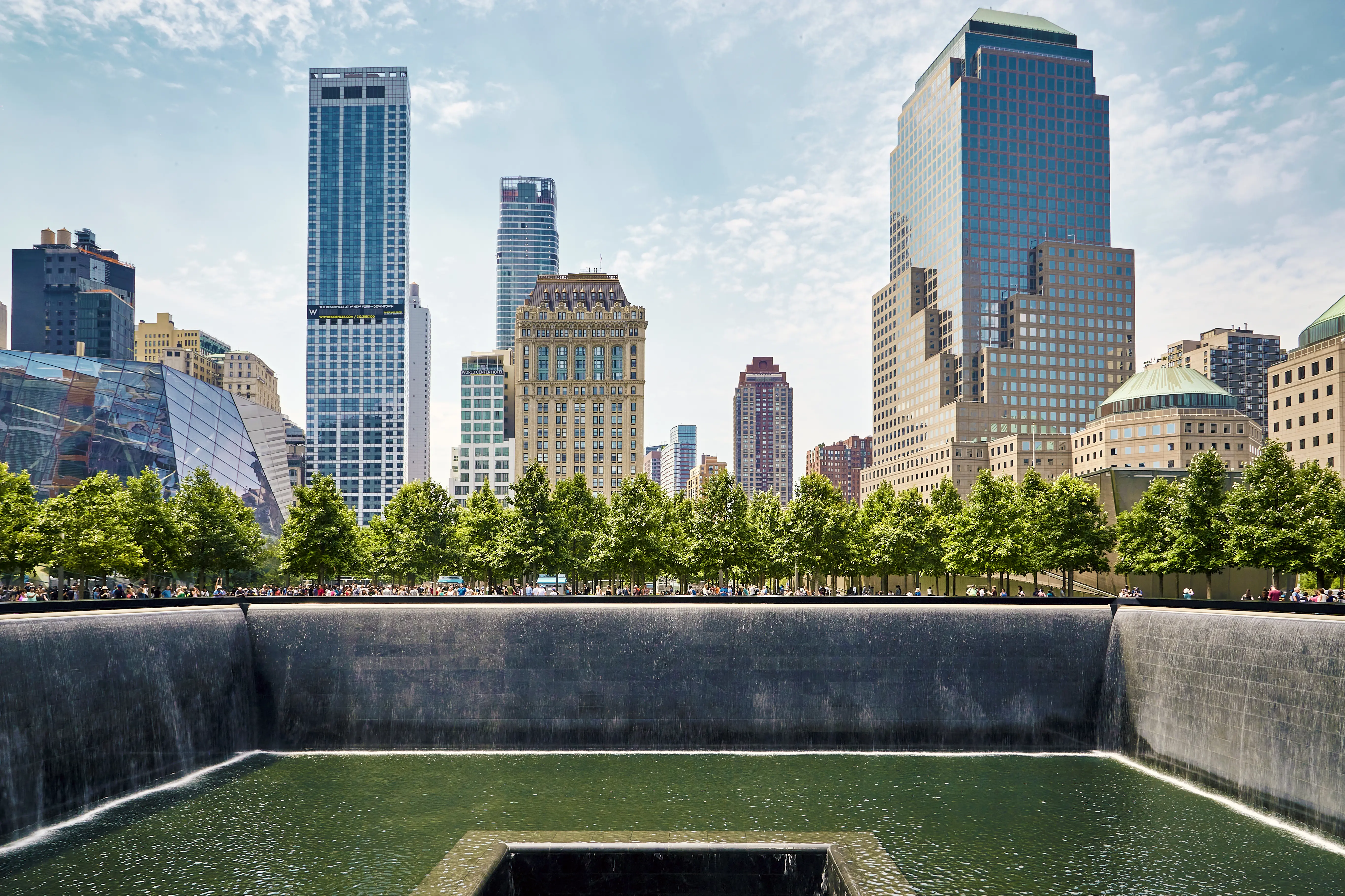 The 9/11 Memorial south pool with the buildings of Manhattan, New York in the background
