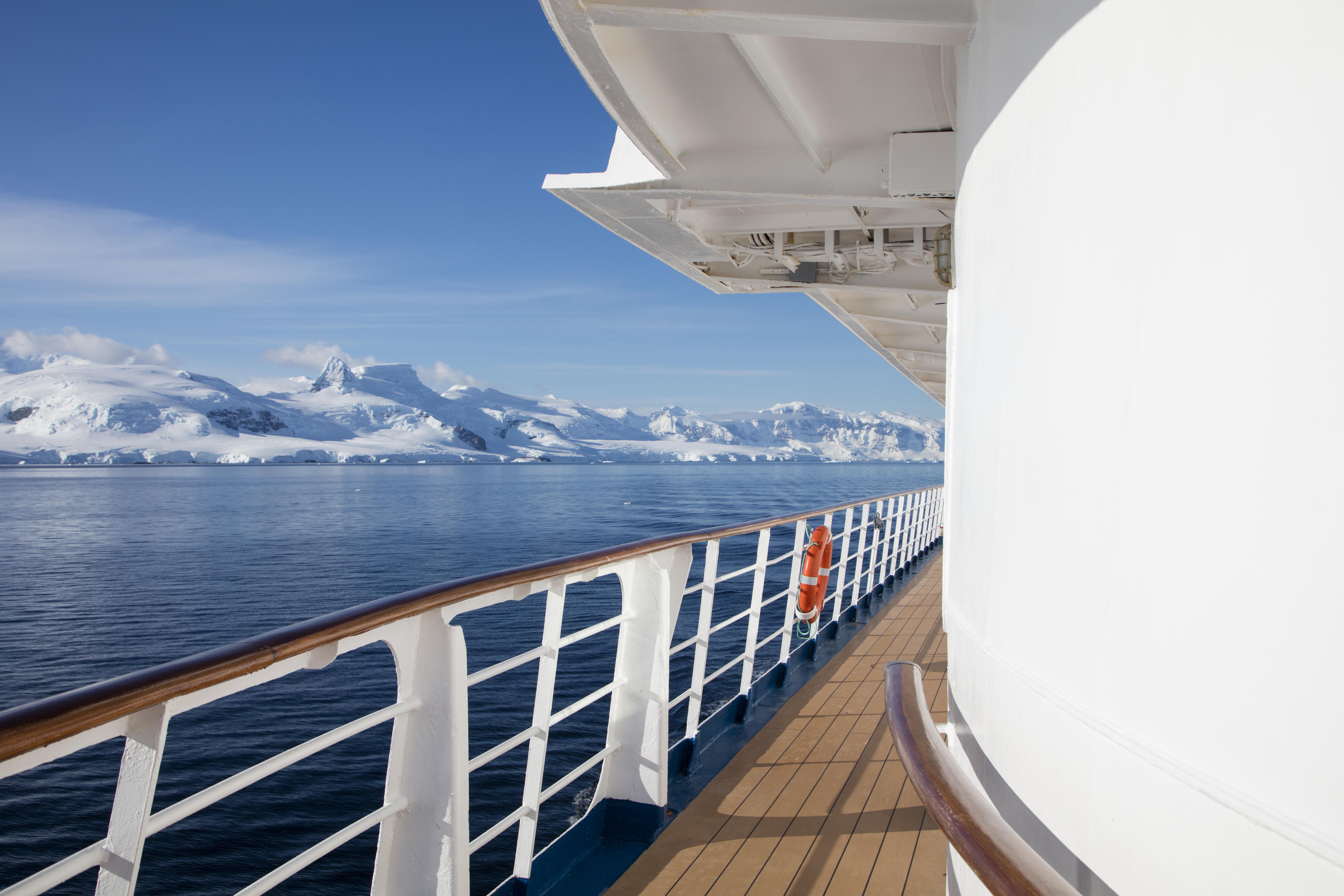 Deck of expedition cruise ship MV Sea Spirit (Poseidon Expeditions) and snow-covered mountains, Gerlache Strait, Graham Land, Antarctic Peninsula, Antarctica