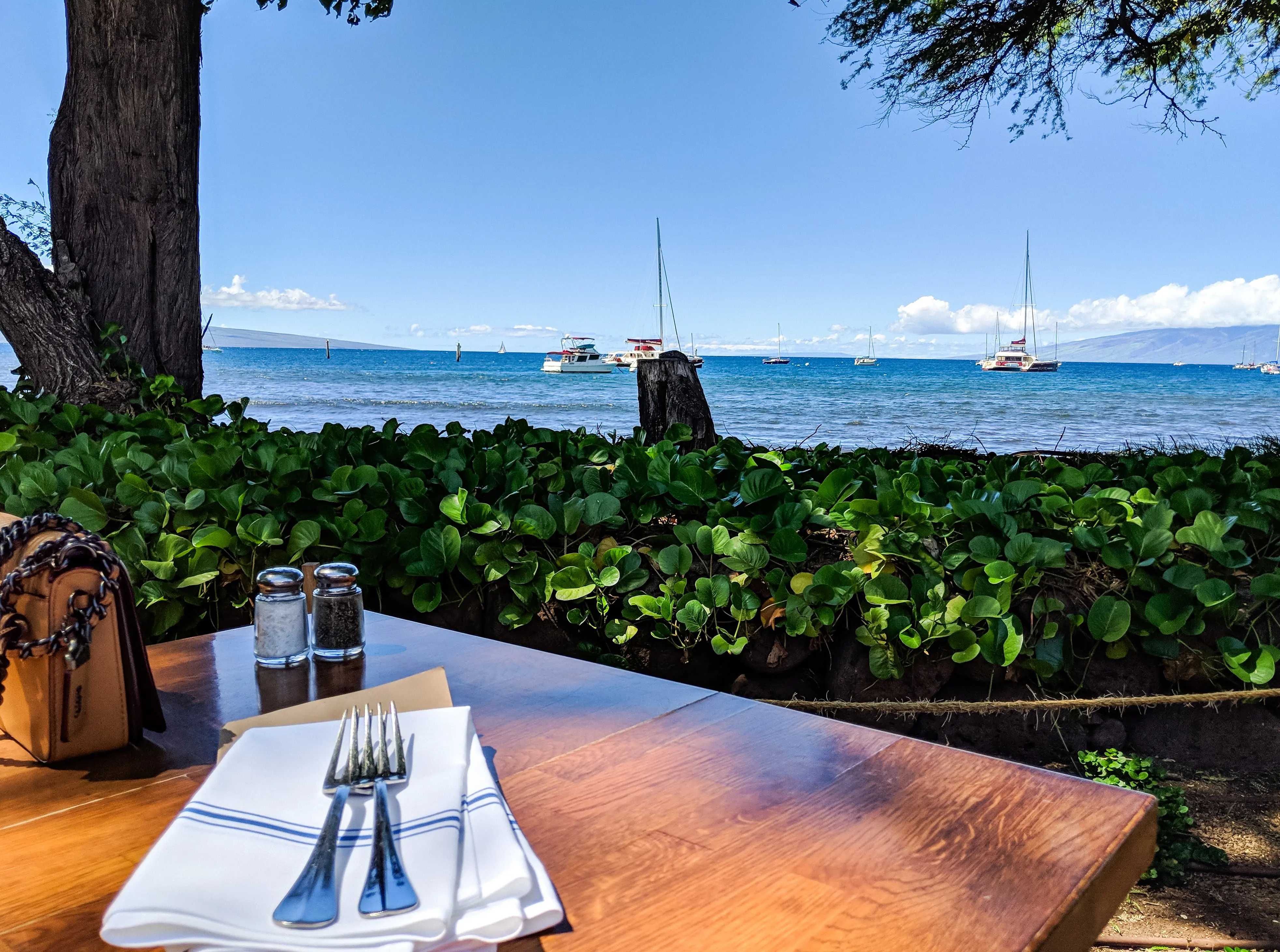 Beautiful Beach Cafe with view of the sea and boats on Kauai Maui, Hawaii