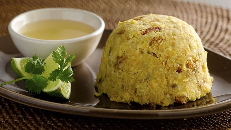 Image of the Caribbean dish Mofongo, made by mashing fried green plantains into a tight mound.
