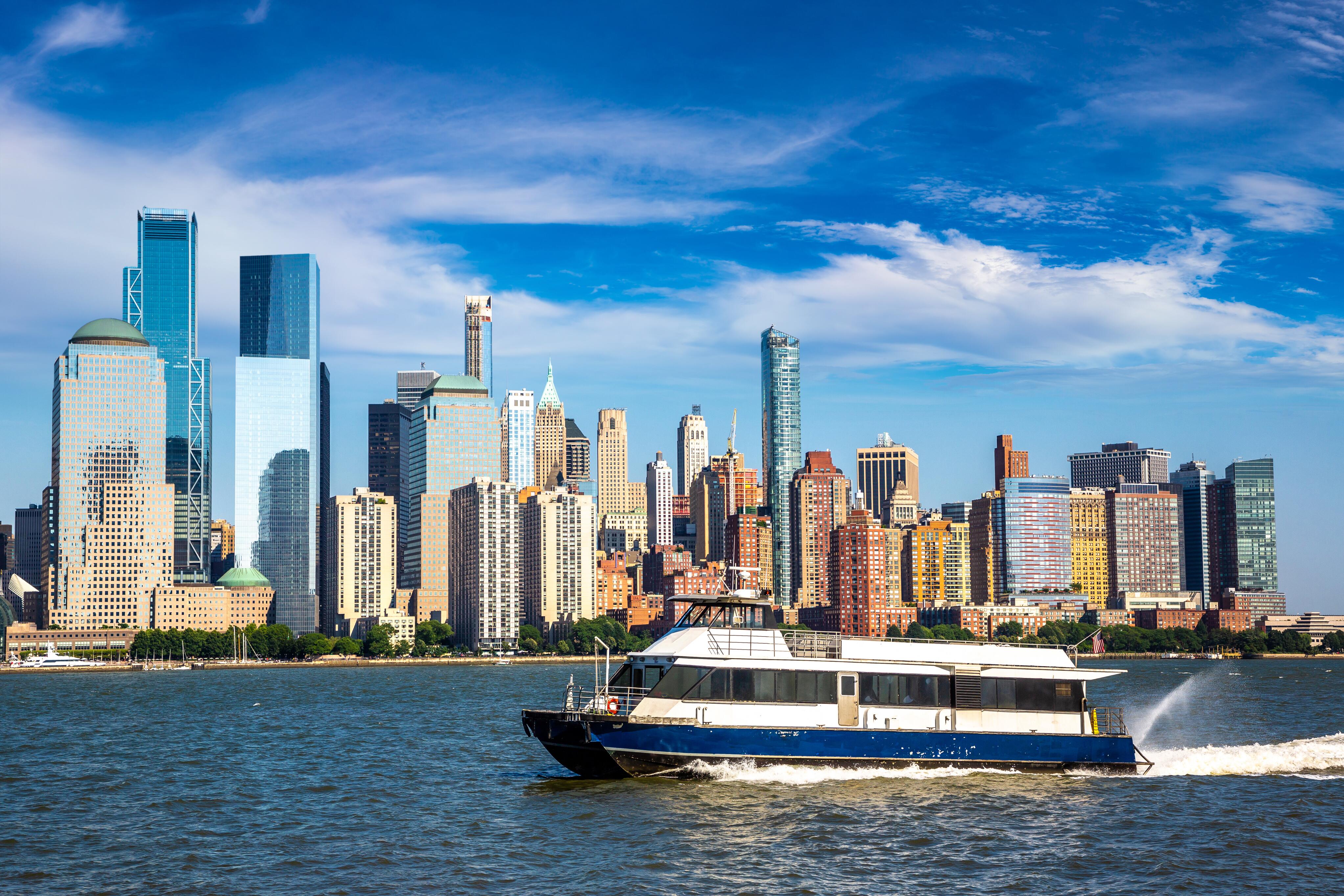 New York waterway ferry boat on the Hudson River against Manhattan cityscape background, USA