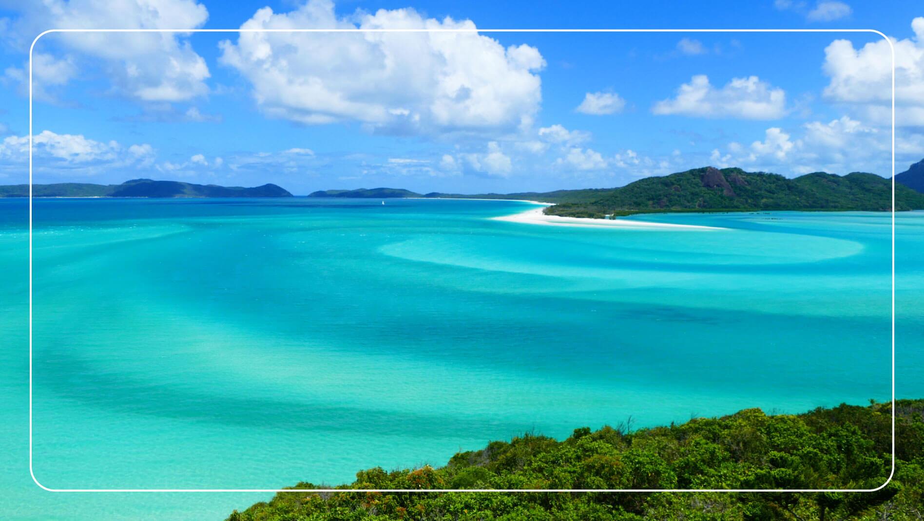 Aerial view showing white sands and azure waters of Whitehaven Beach, Whitsundays