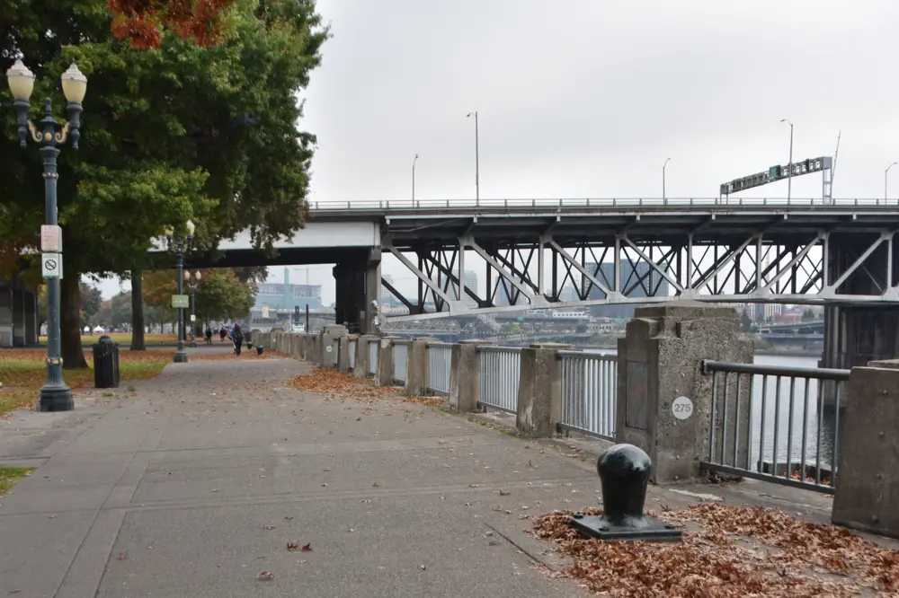 A wide walking path along the riverfront at Governor Tom McCall Waterfront Park in Portland, Oregon.