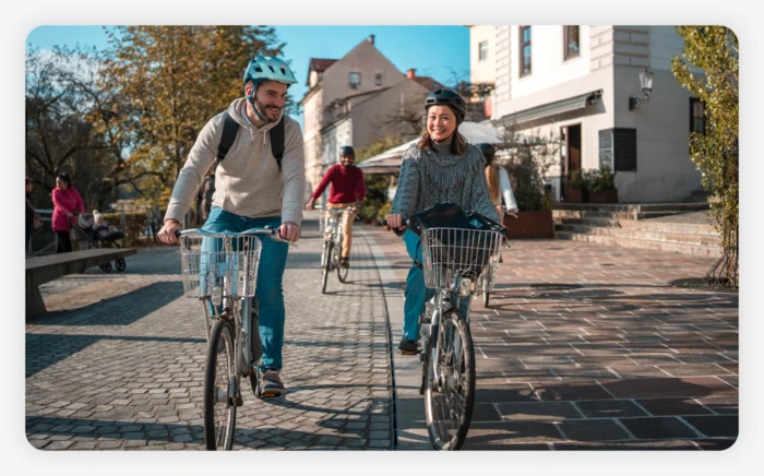 A couple enjoying a bike ride around paved streets