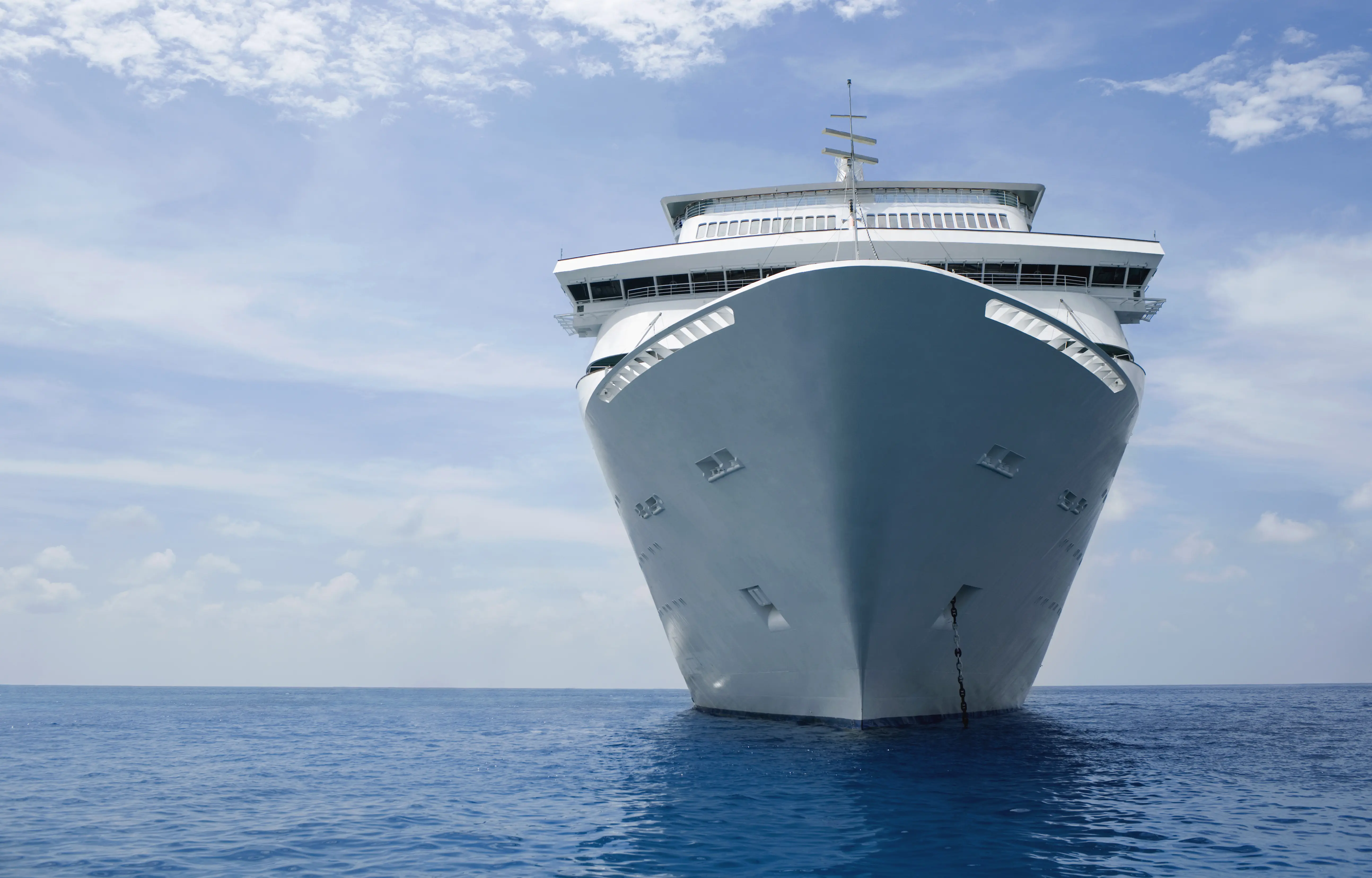 Image of a cruise ship on the ocean, taken from a front-facing angle.