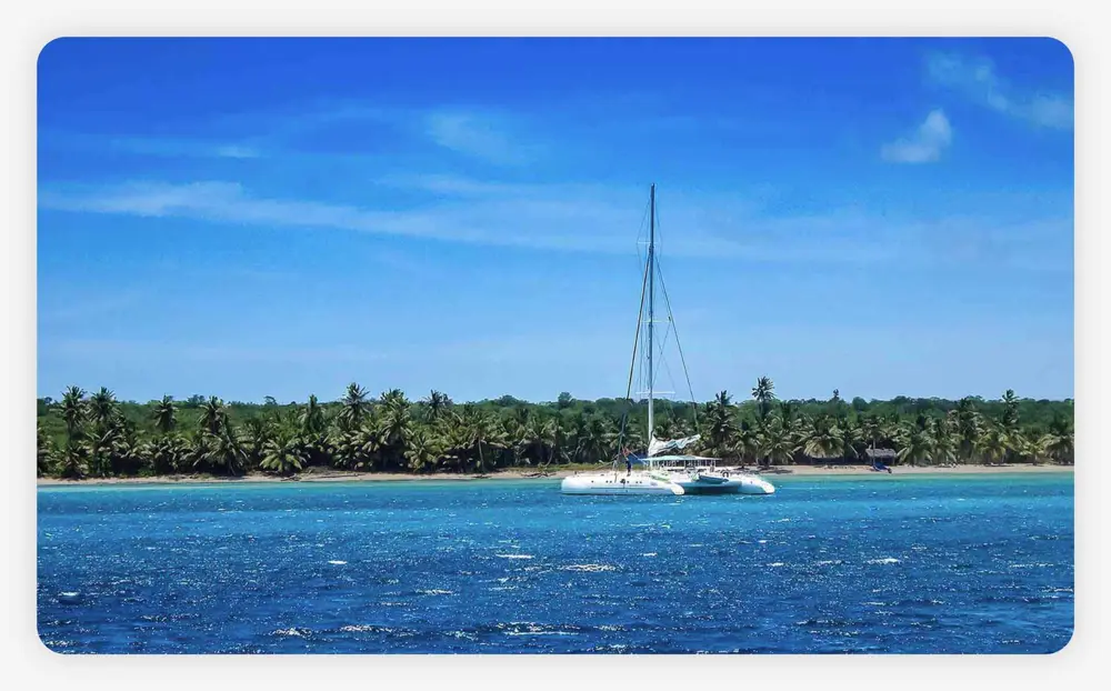 A catamaran cruise boat anchored along Soana Island in the Dominican Republic.