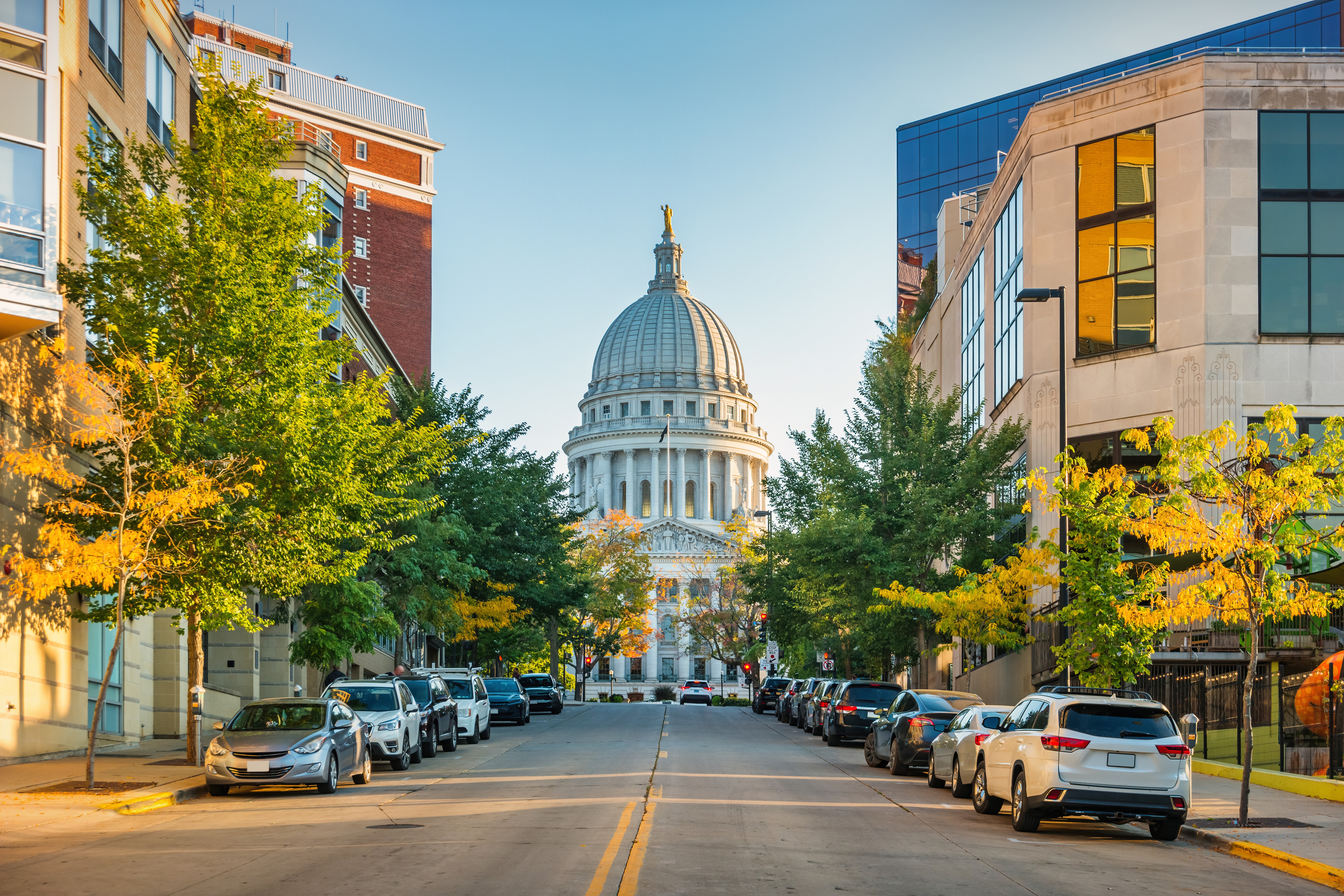 Image of the State Capitol building in Madison, Wisconsin, with surrounding fall foliage.