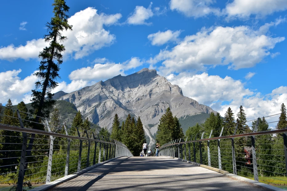 The Banff Pedestrian Bridge with mountains in the background in Banff National Park, Alberta.