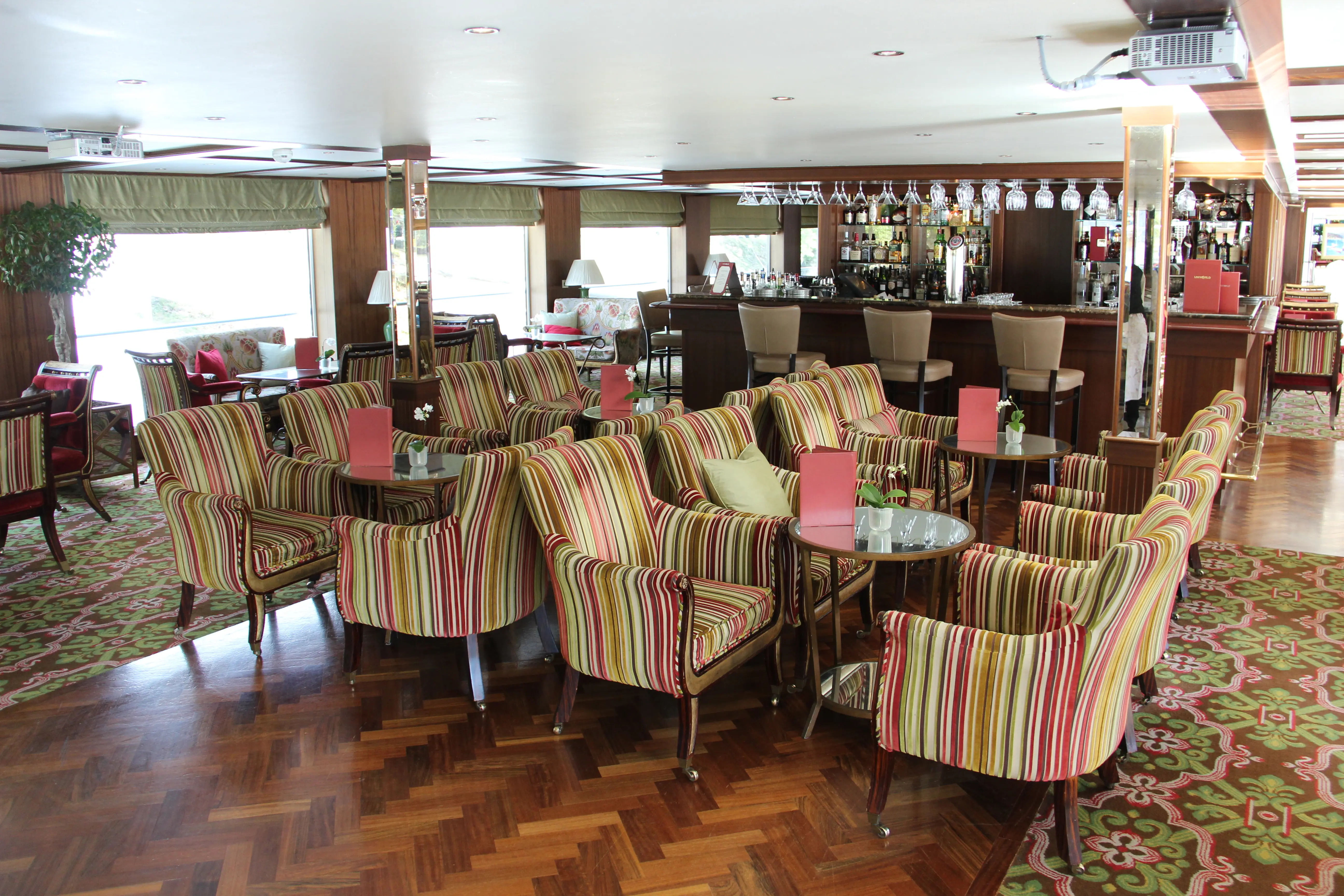 Image of the interior sitting space and bar of a Uniworld River Cruise.