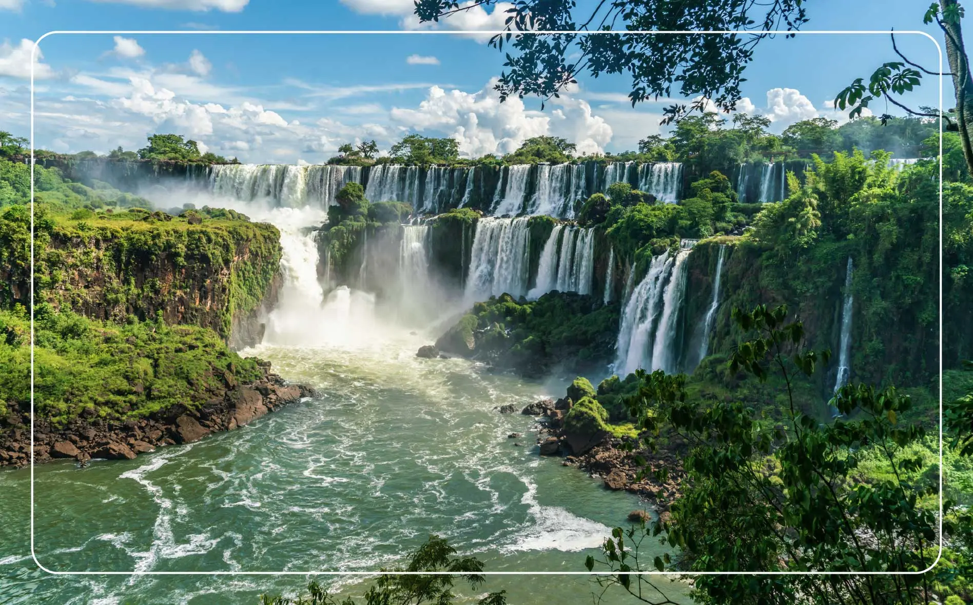 The Iguazú Falls between Argentina and Brazil on a sunny day.