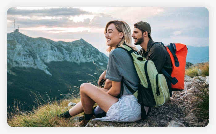 A couple taking in a scenic mountain view on a hike