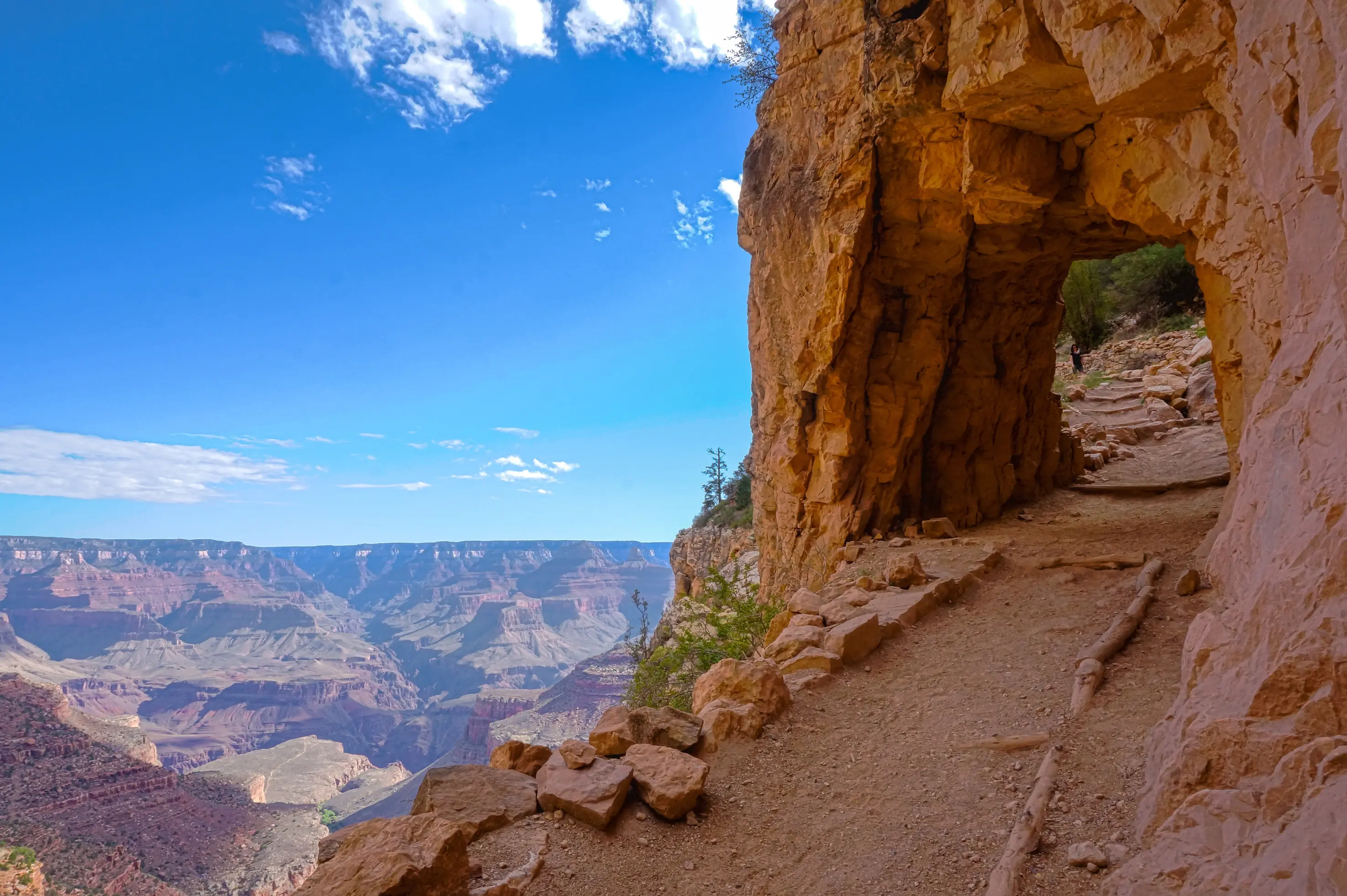 Cliffside path and rock tunnel on Bright Angel Trail overlooking the canyons in Grand Canyon National Park