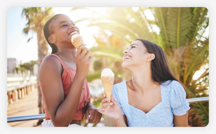 A couple enjoying an ice cream cone on a sunny day