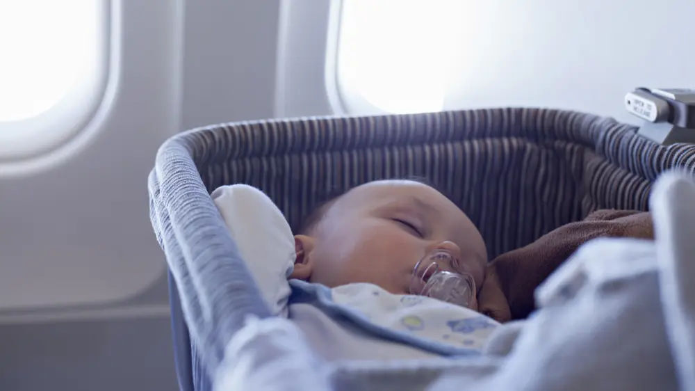Baby sleeping in carrier on airplane