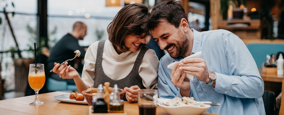 A couple enjoying a meal at a restaurant in Boston