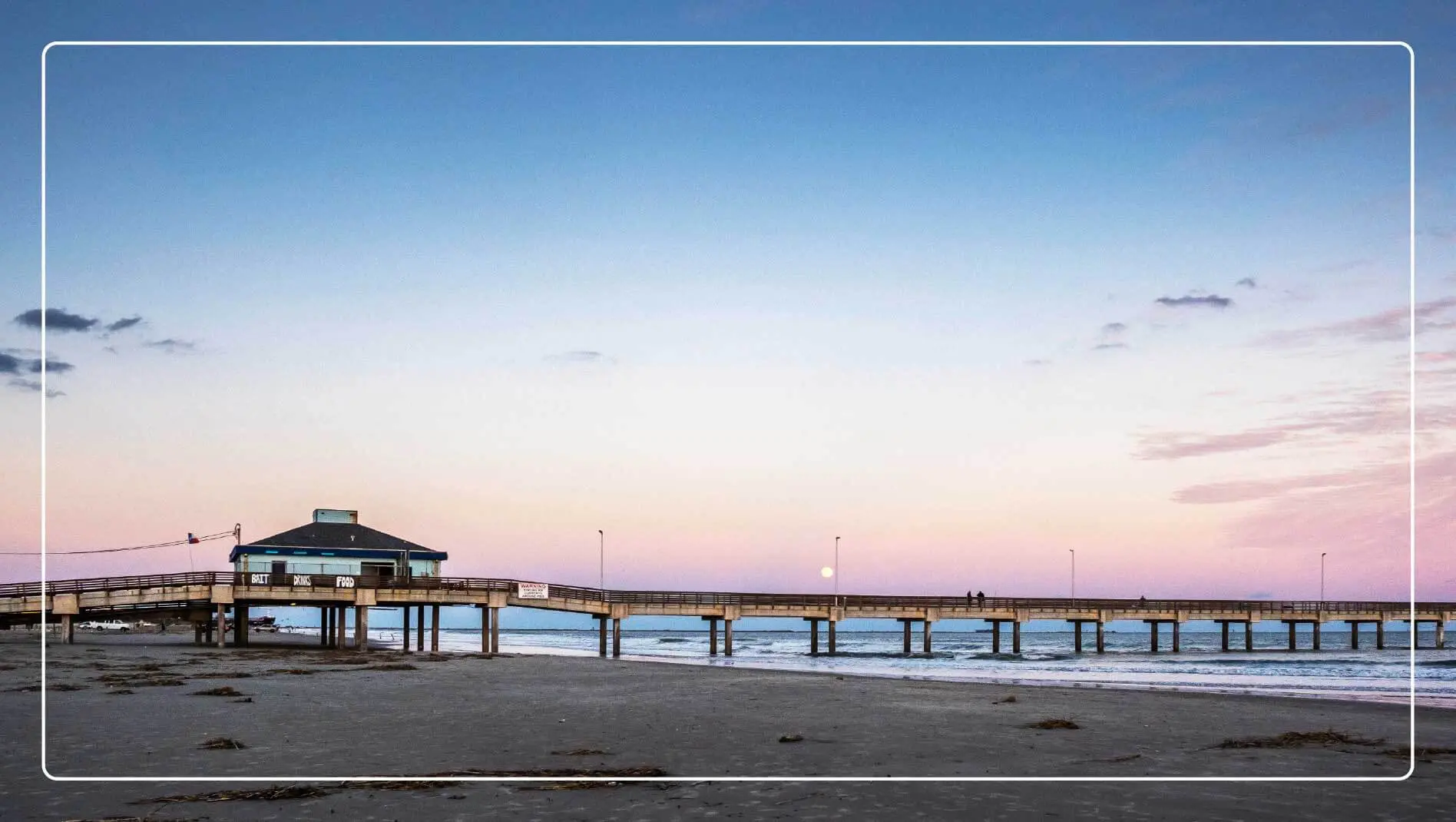 A view of the Port Aransas pier as seen from the sand.