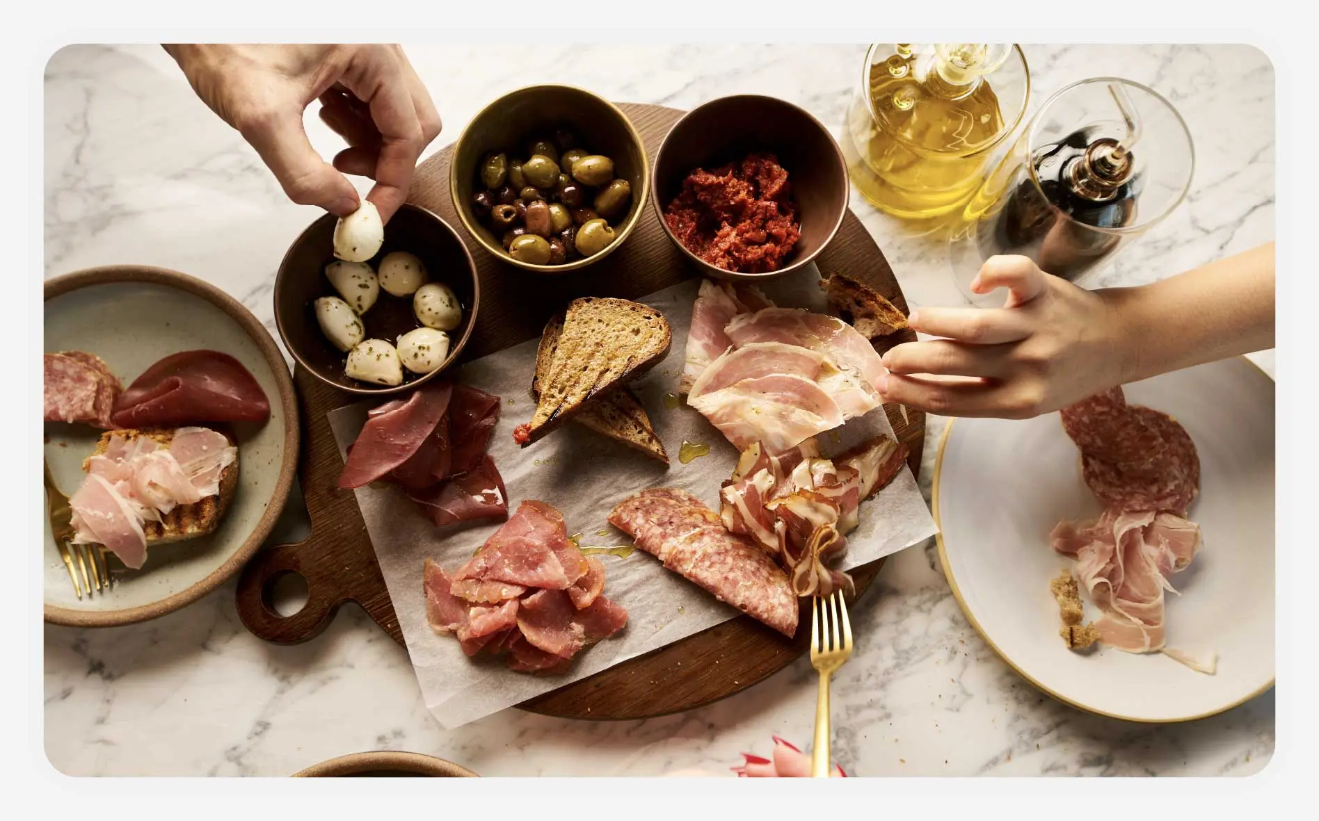 Friends sharing a charcuterie board during a meal