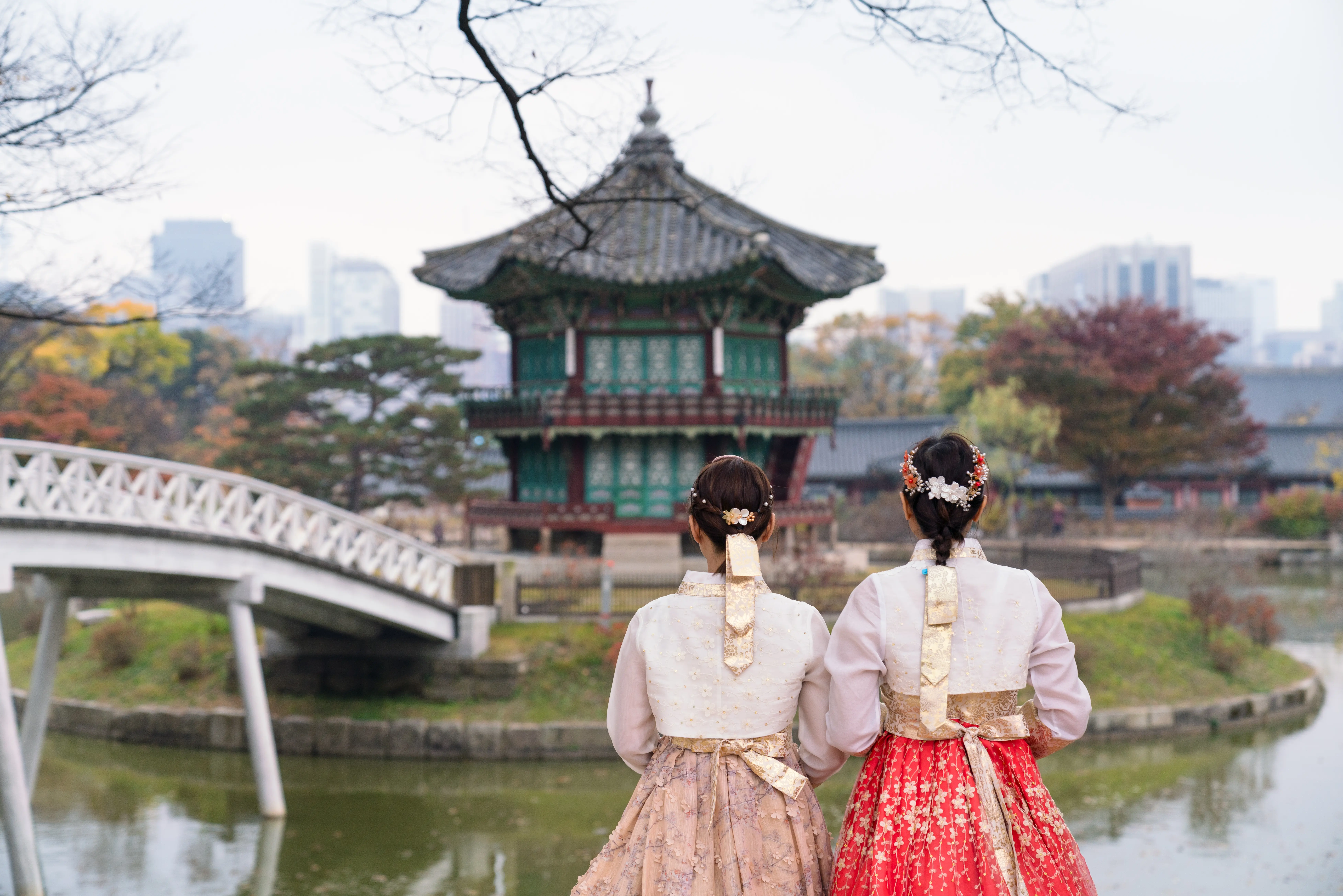 Photo of two women in traditional korean wear outside a historic temple in Seoul, South Korea