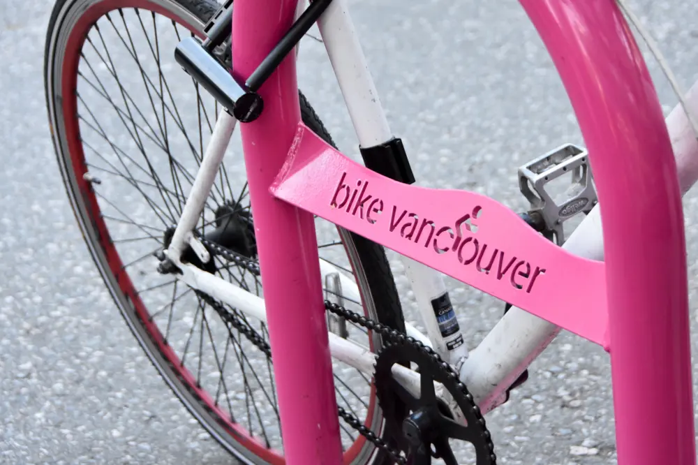 Pink bike rack with a bicycle chained to it in Vancouver British Columbia