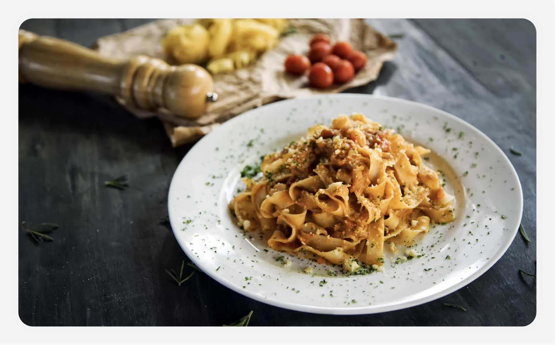 A handmade pasta dish with pappardelle noodles.