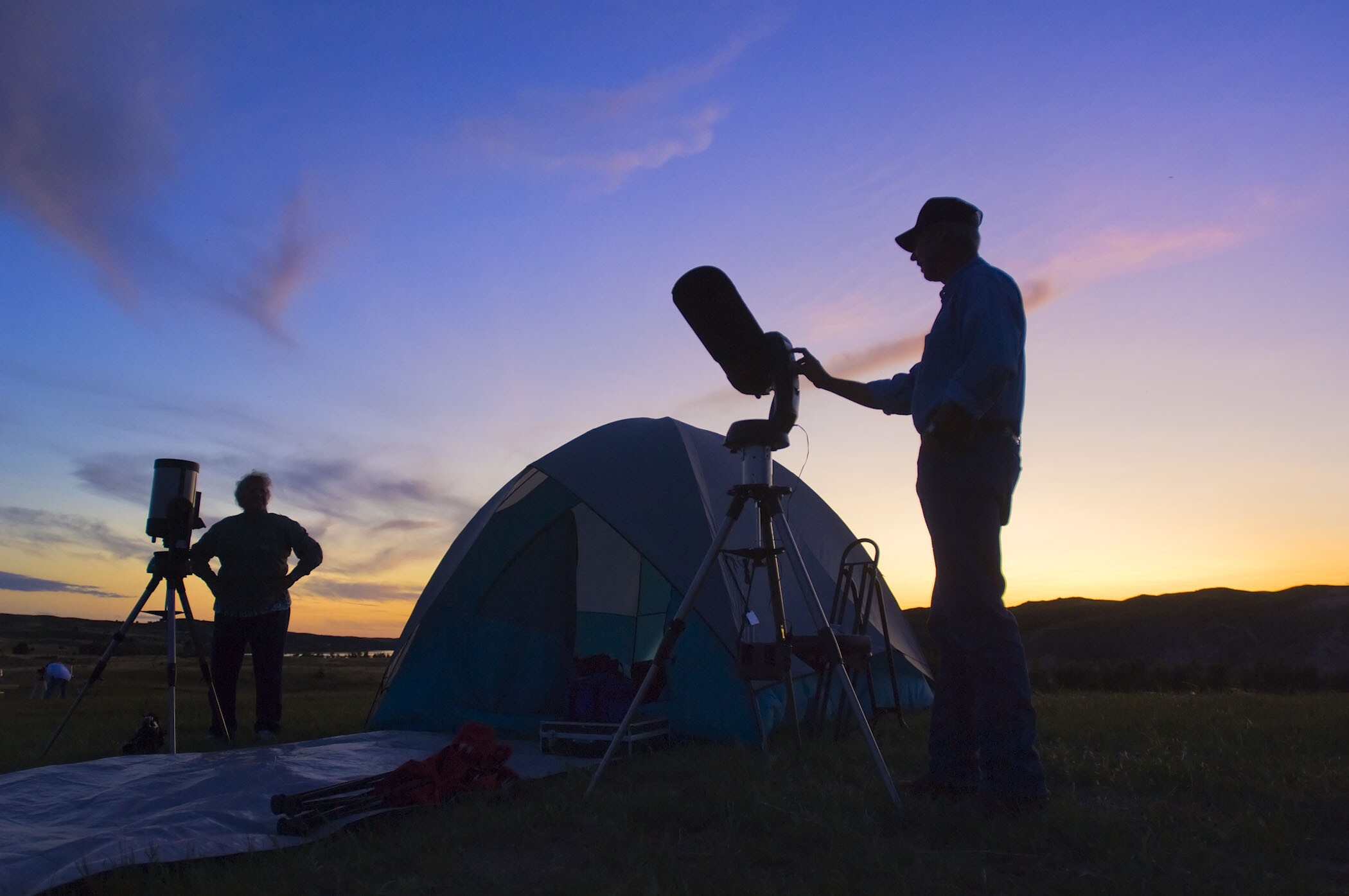 Men viewing starry sky through telescopes