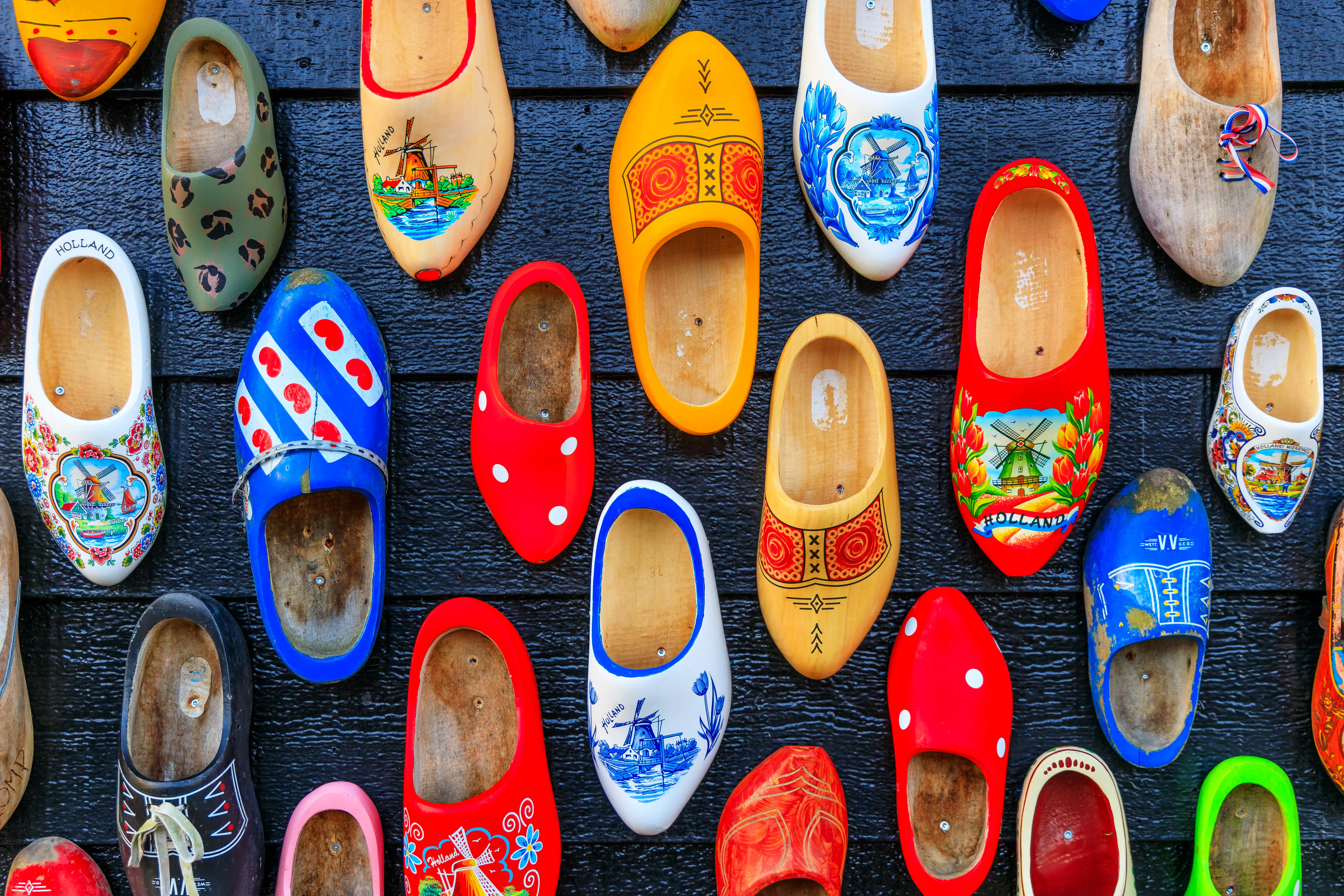 Colorful ooden clogs painted with different regional motifs, traditional footwear in the Netherlands