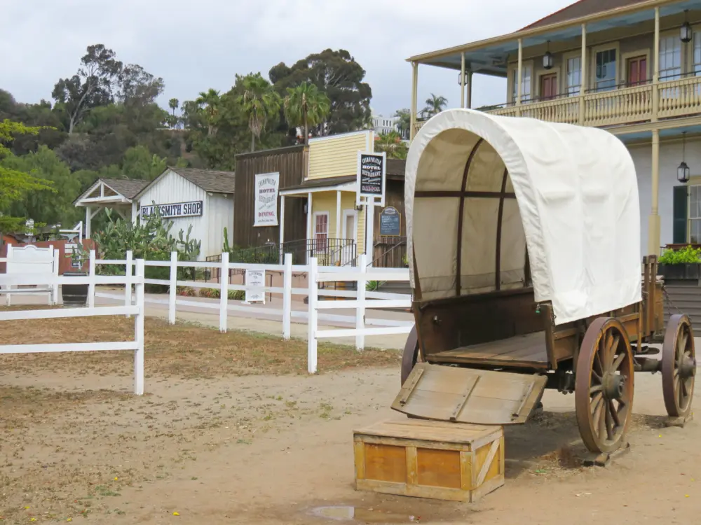 Covered wagon in front of historic buildings at Old Town San Diego State Historic Park in San Diego, California