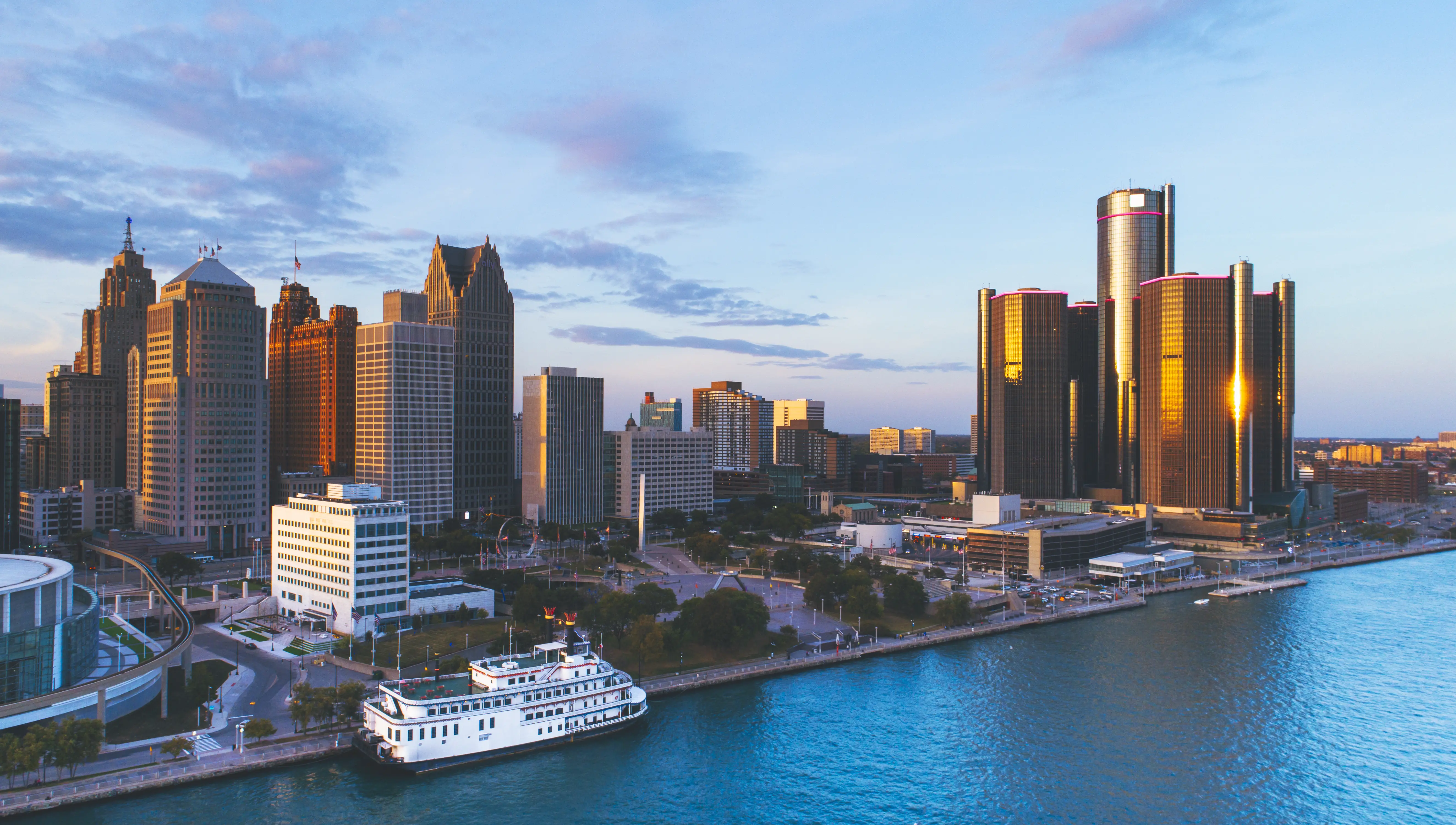 Aerial image of the Detroit River, with a cruise visible on the water.
