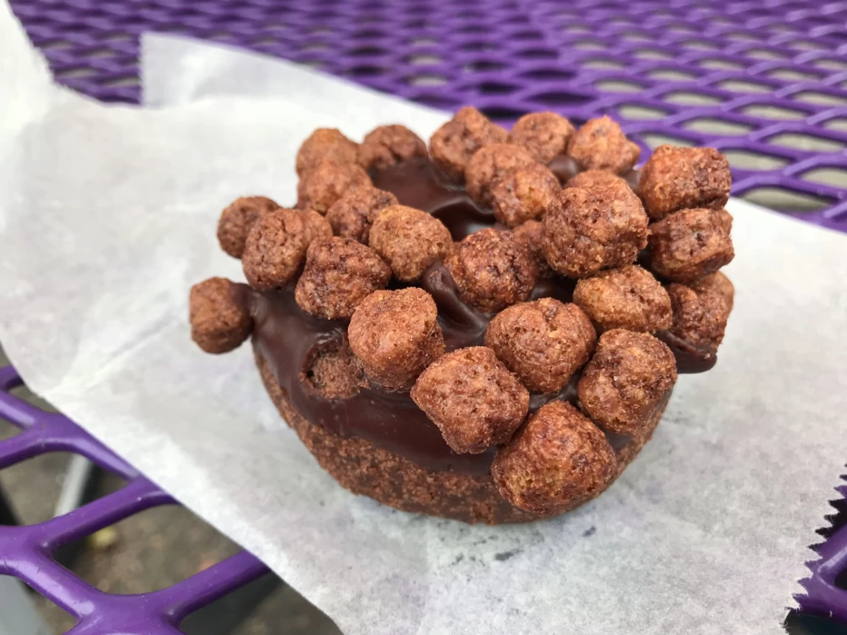 Triple Chocolate Penetration donut topped with Cocoa Puffs at Voodoo Doughnut in Portland, Oregon.