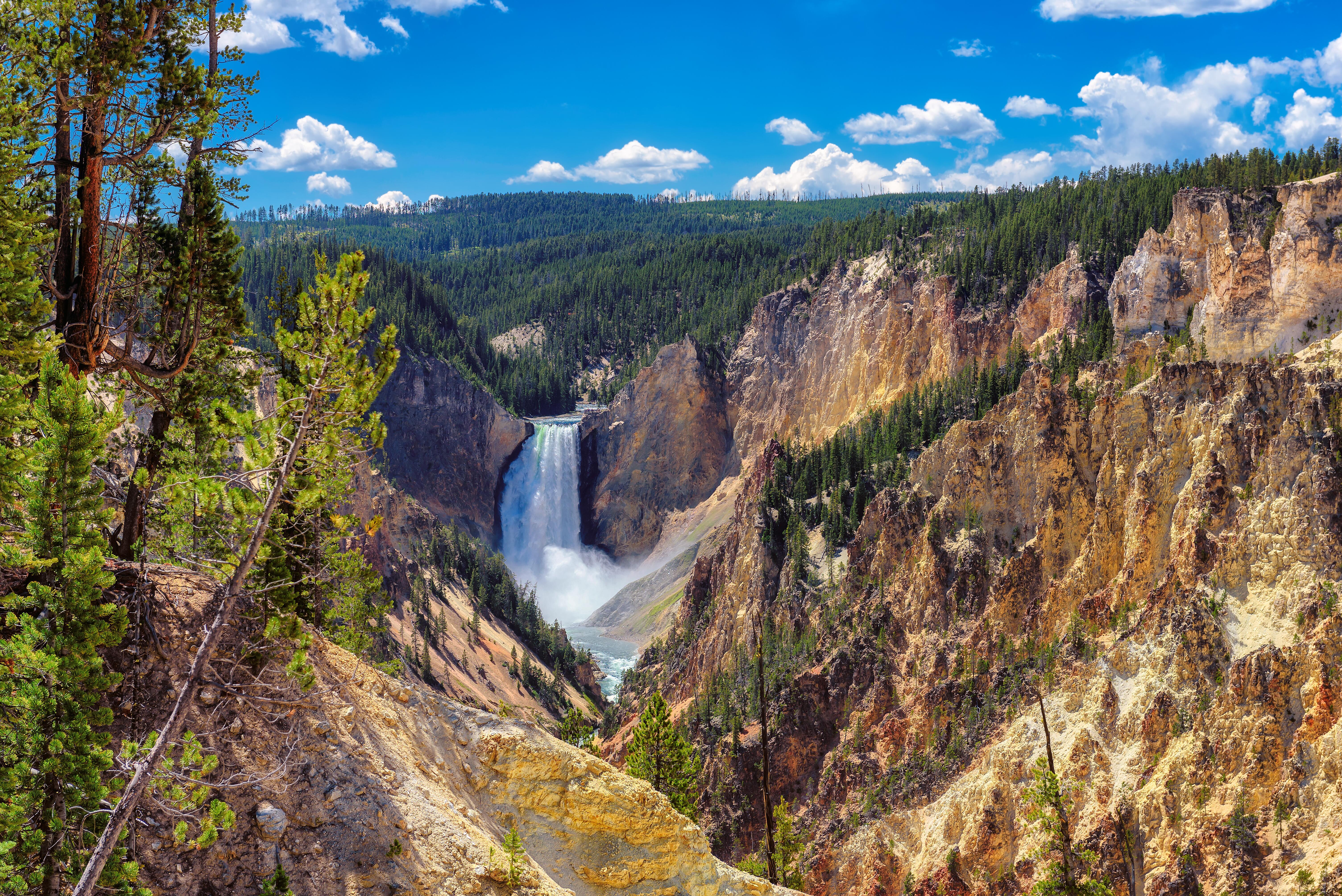 Elevated breathtaking view of waterfall and mountains, called the Grand Canyon of Yellowstone National Park, in Lower Falls