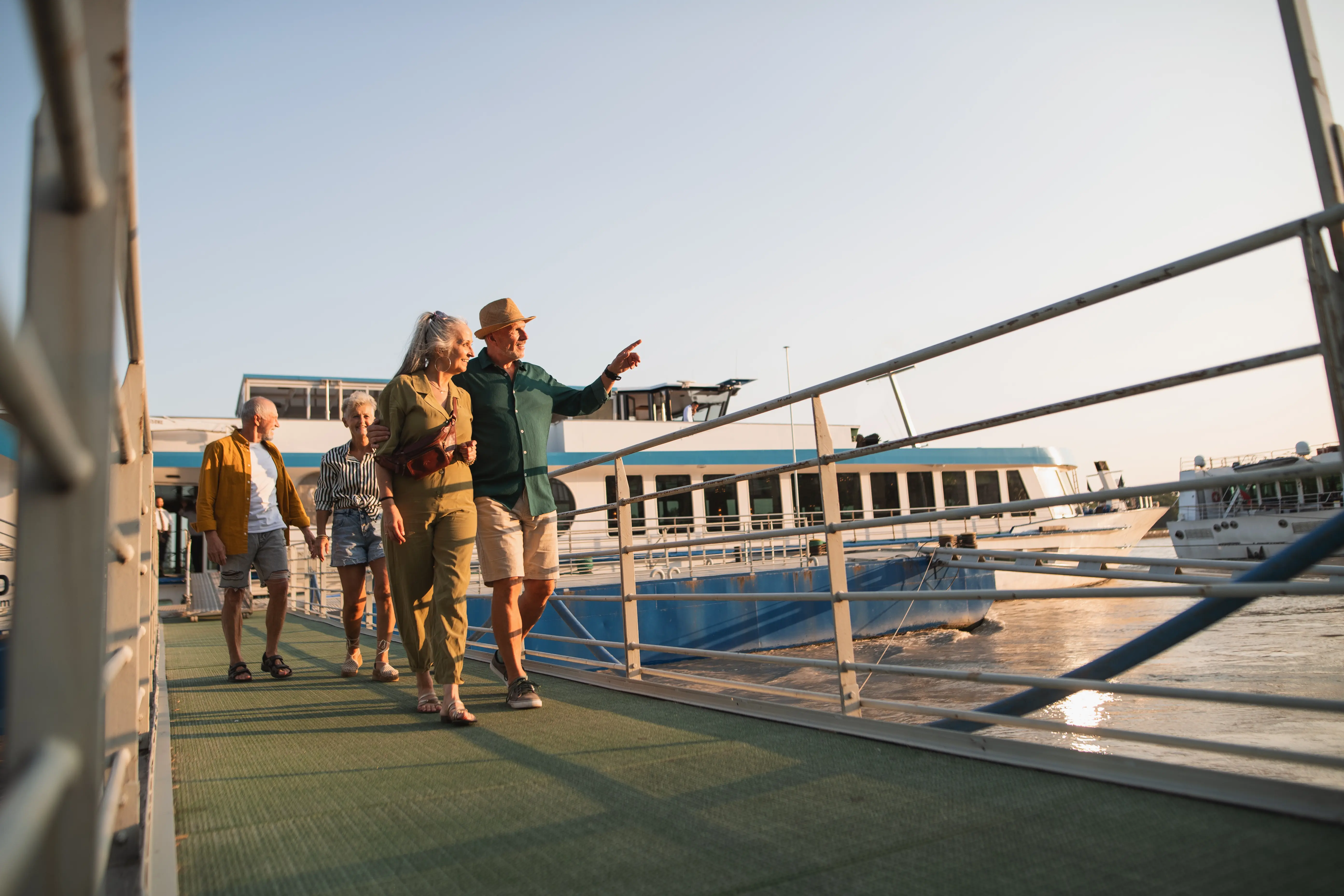 Image of tourists walking by a river cruise boat.