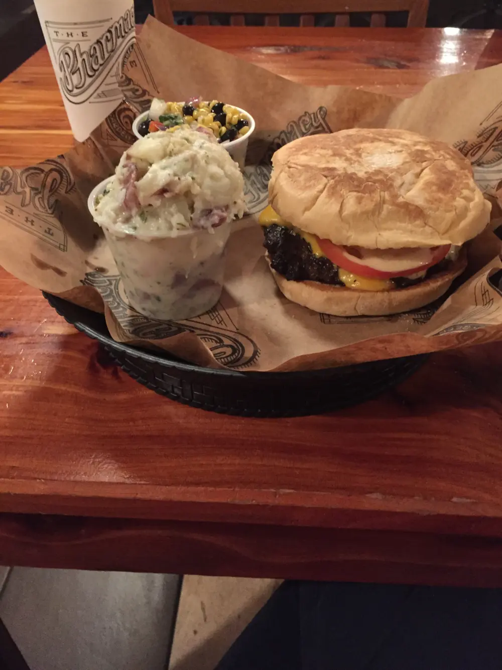 Burger with potato salad and corn black bean salad