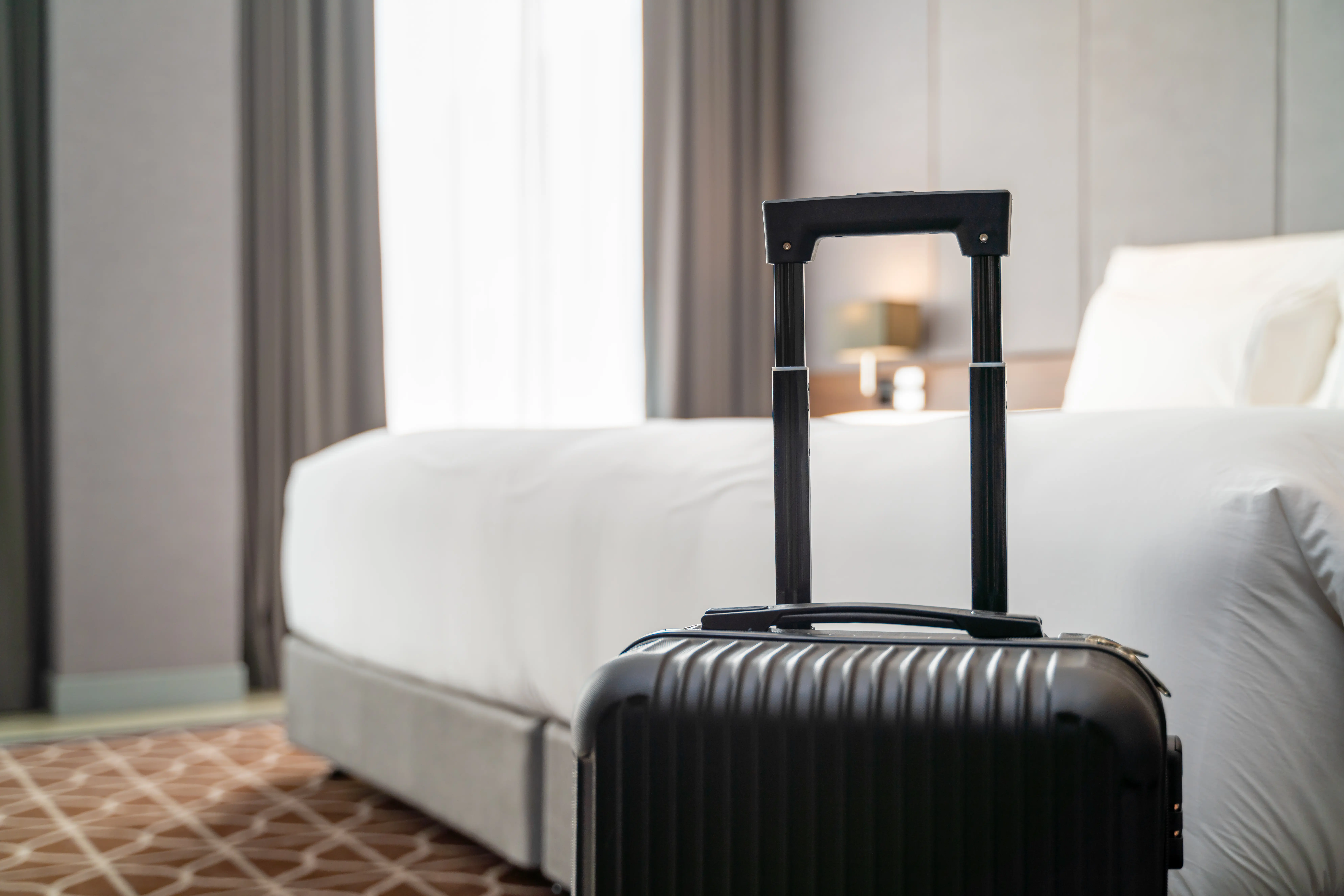 Image of luggage sitting in a hotel room.