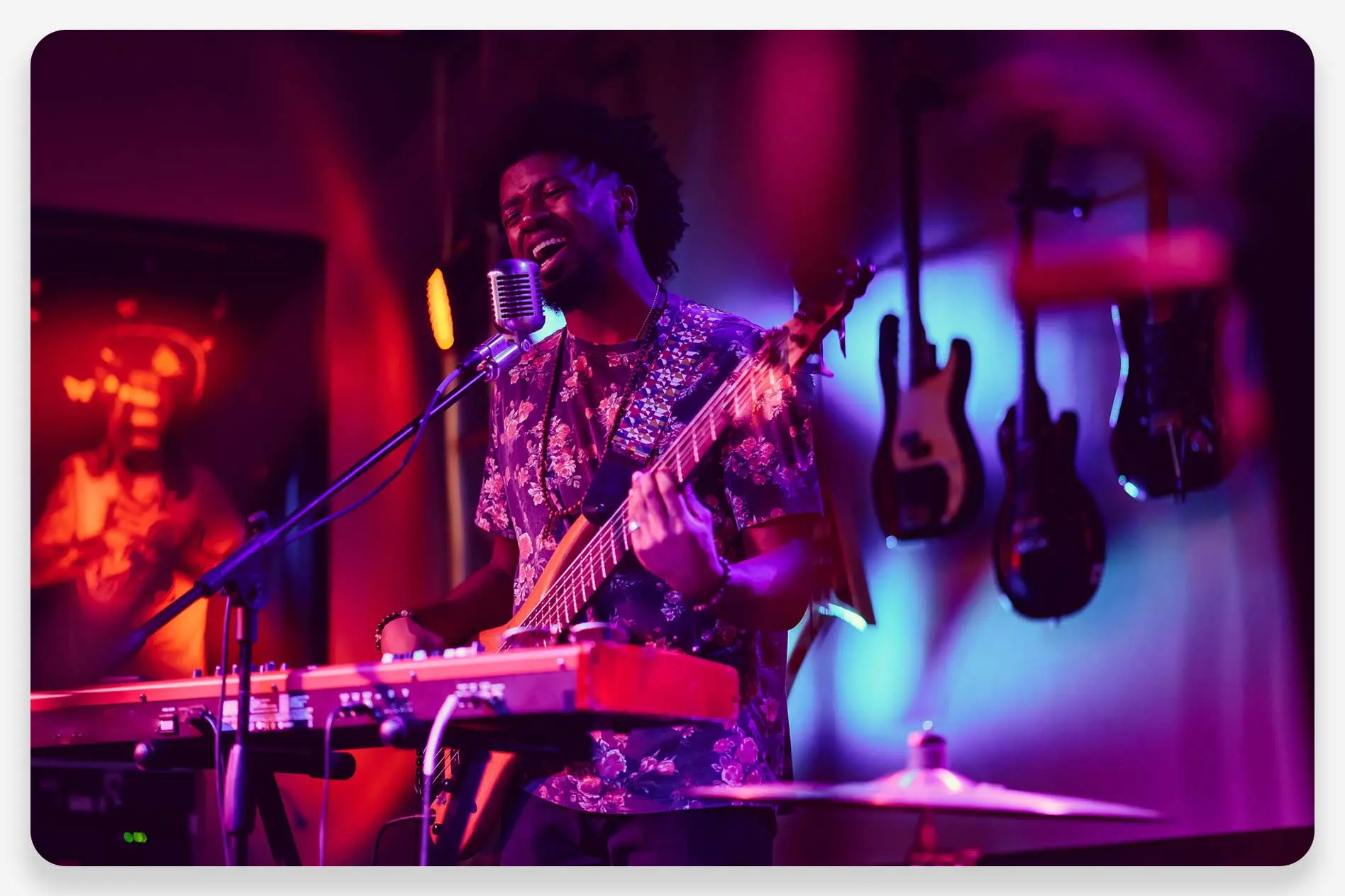 A musician plays guitar inside of a music lounge