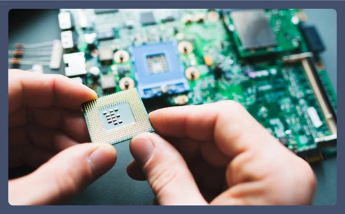 A person examines the motherboard of a gaming PC.