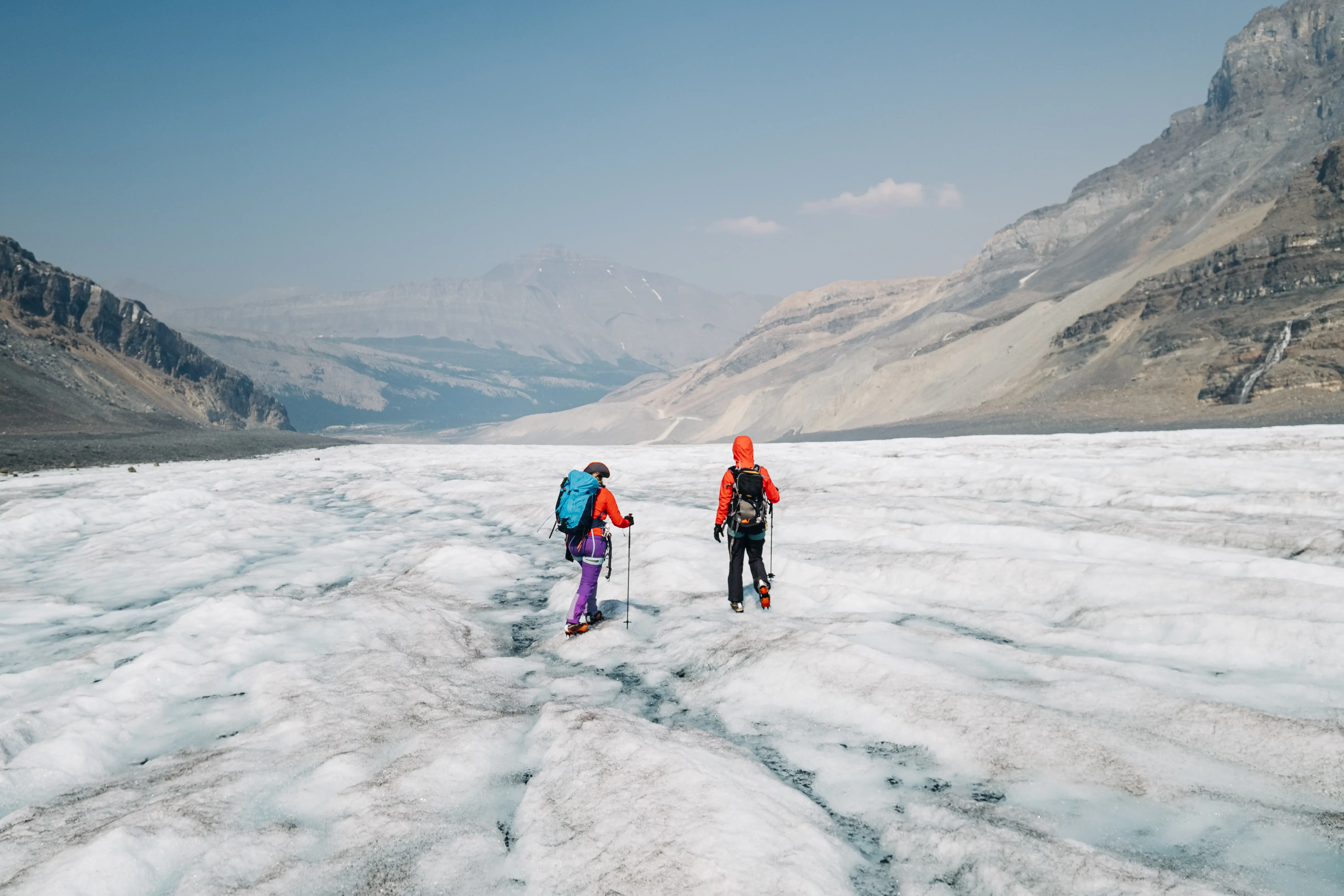 Photo of two people hiking on the Athabasca Glacier in Banff, Canada