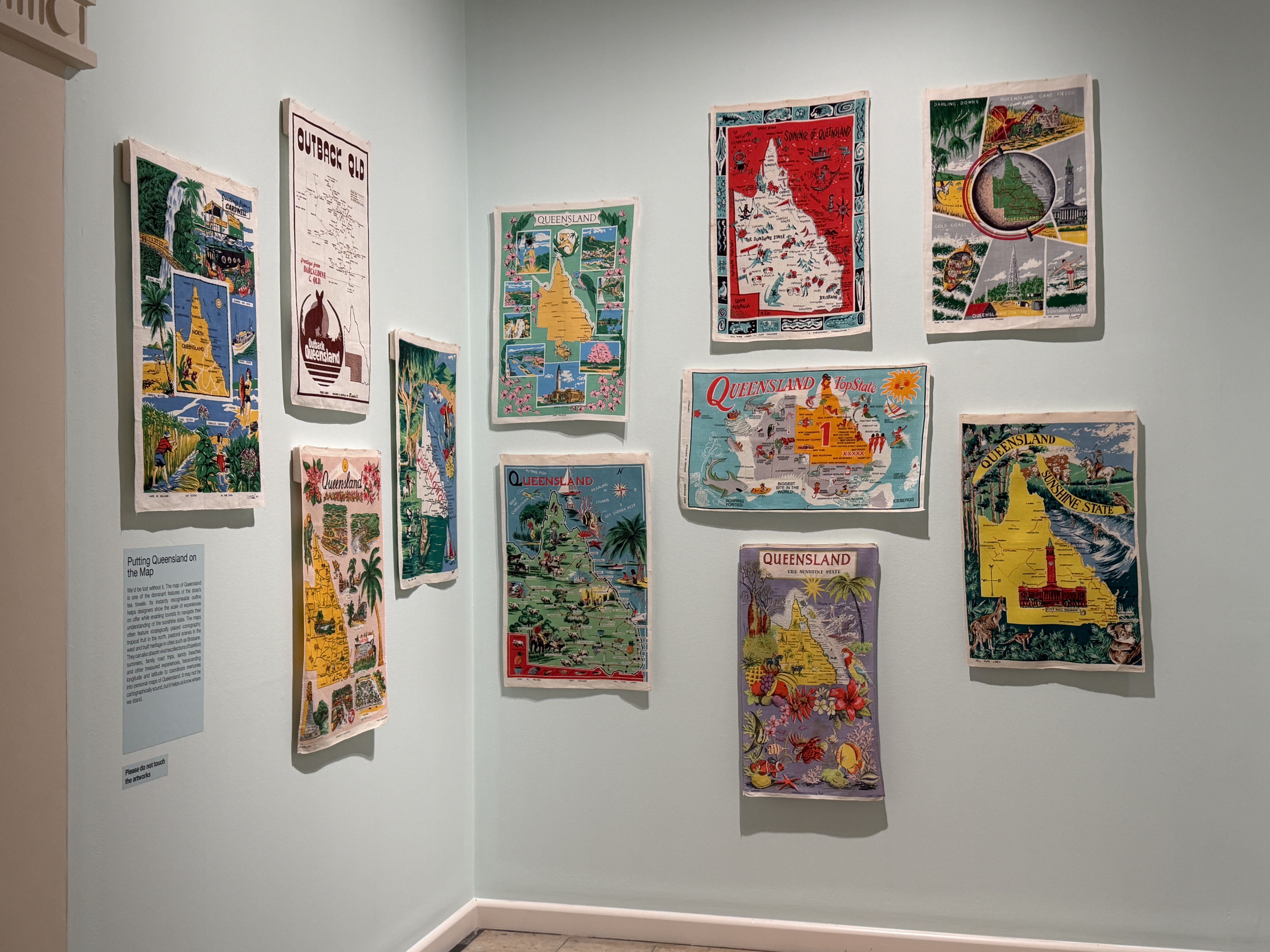 graphic maps of Queensland displayed on a gallery wall