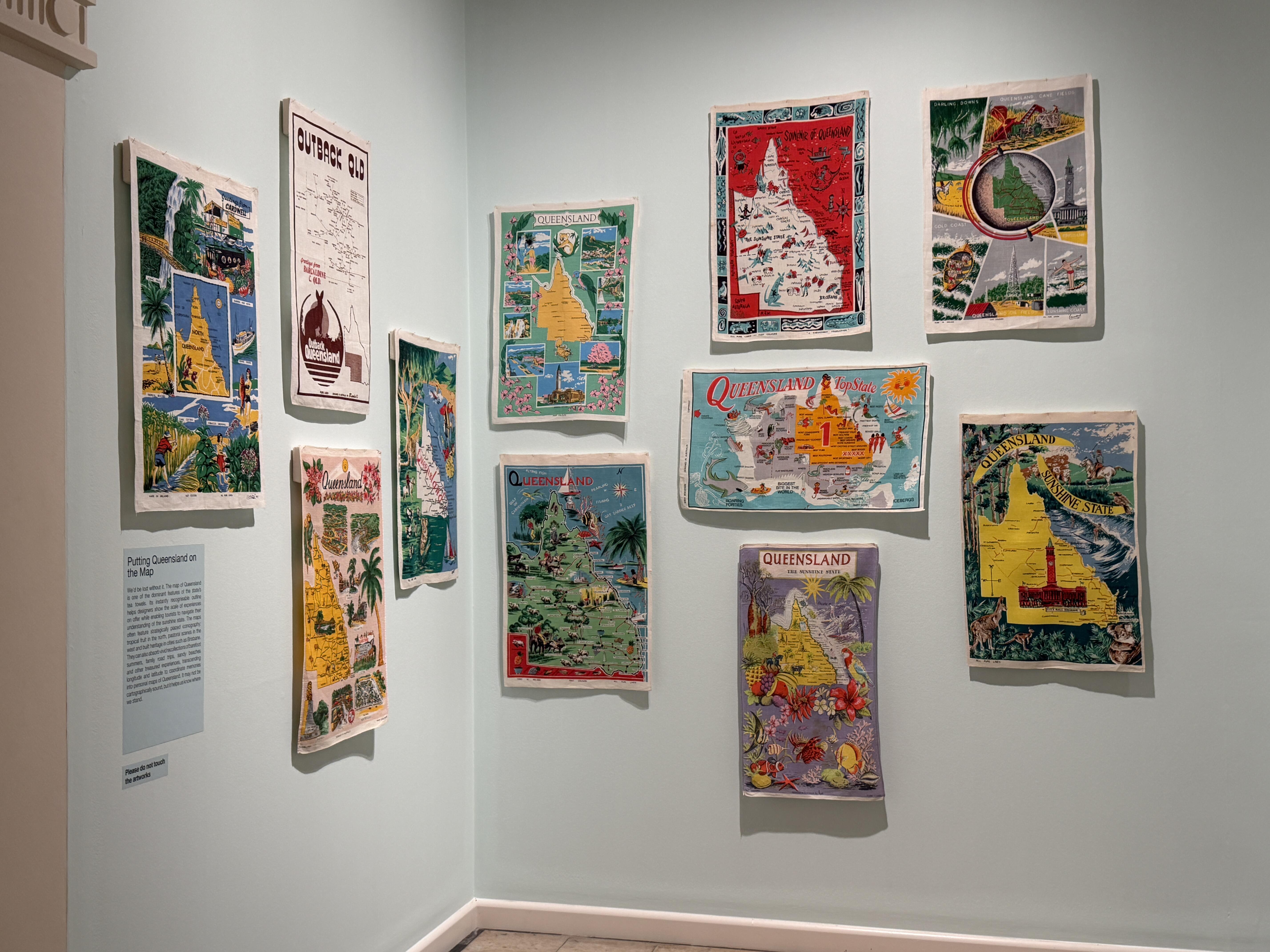 graphic maps of Queensland displayed on a gallery wall