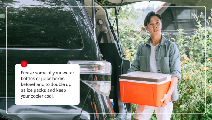 A man packing up his cooler for their road trip. 