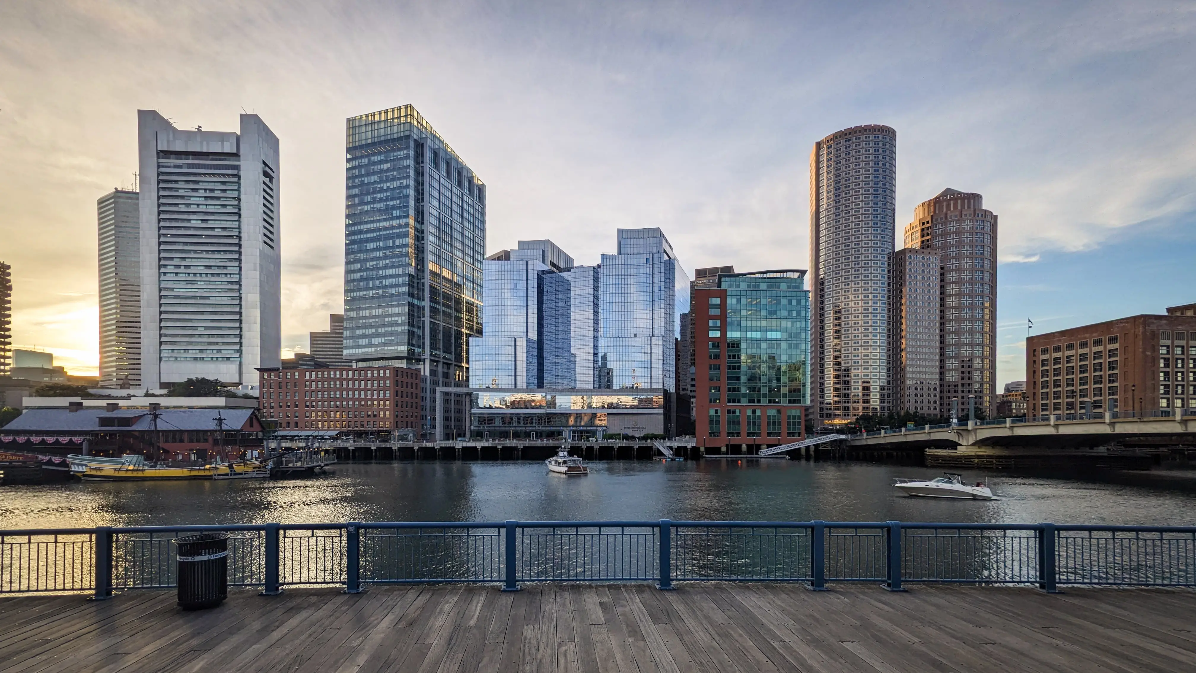 Image of the Boston city skyline beyond the harbor waterfront.