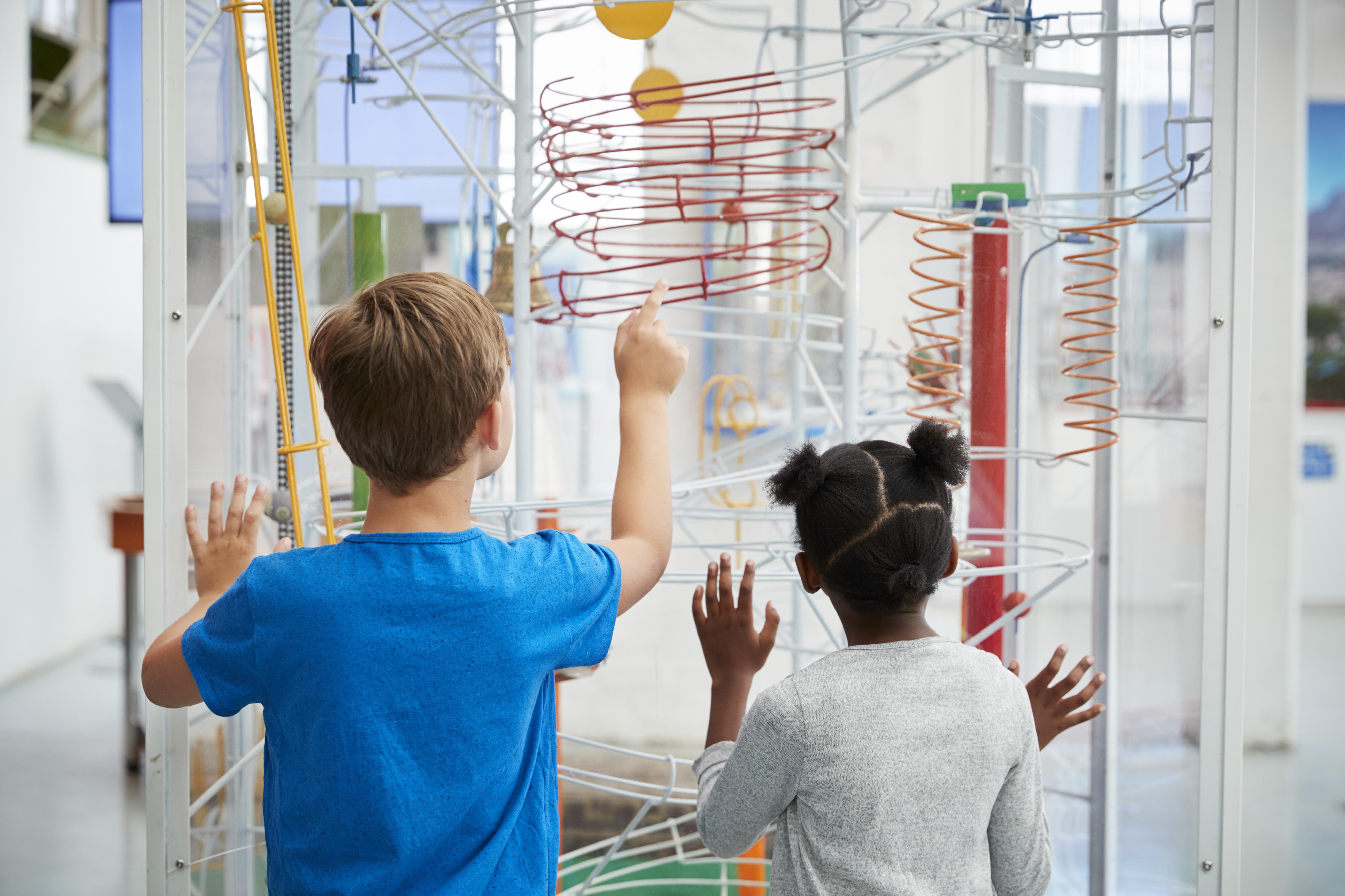 Two children looking at an exhibit in a science museum