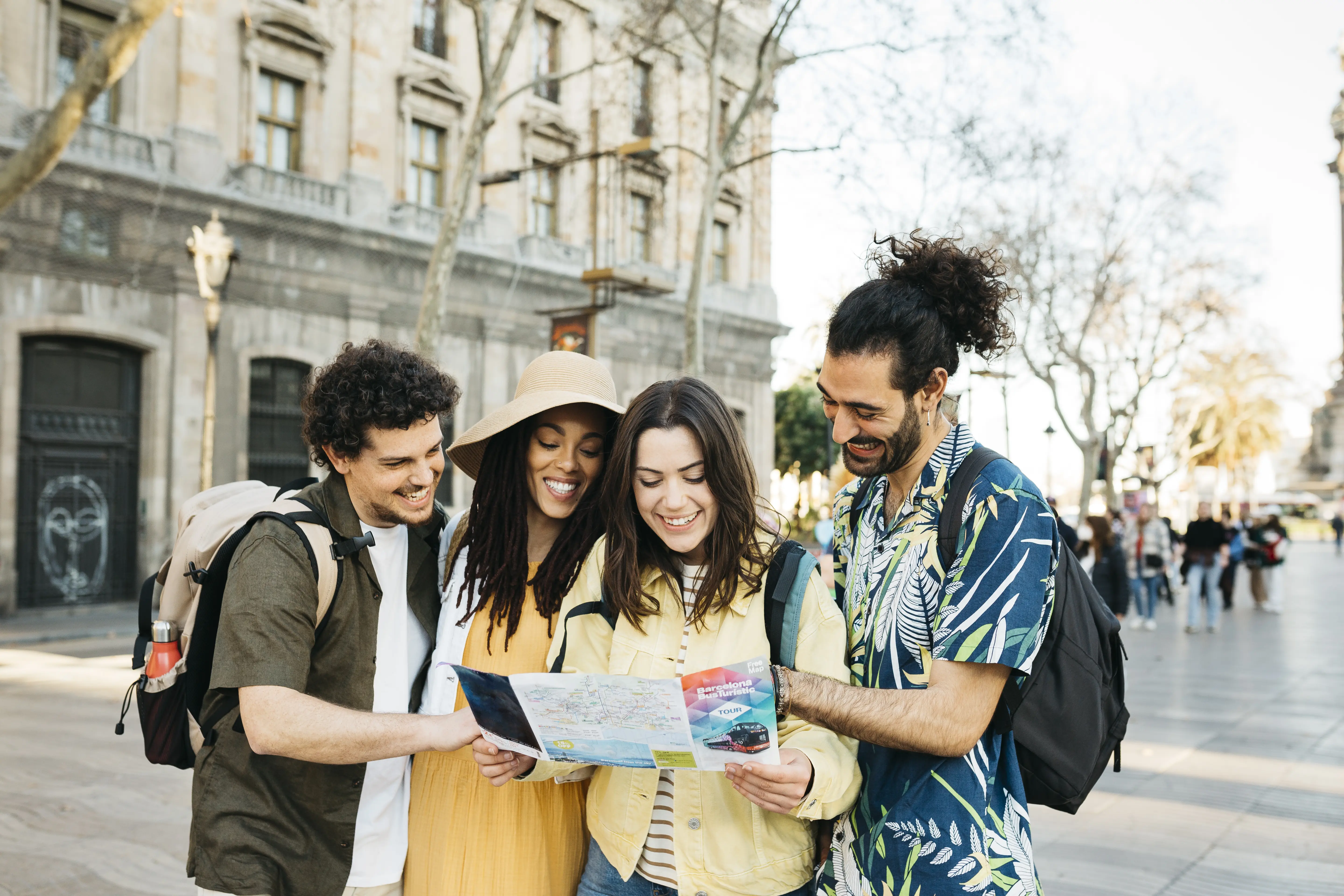 Image of a group of travels using a map while traveling on vacation.