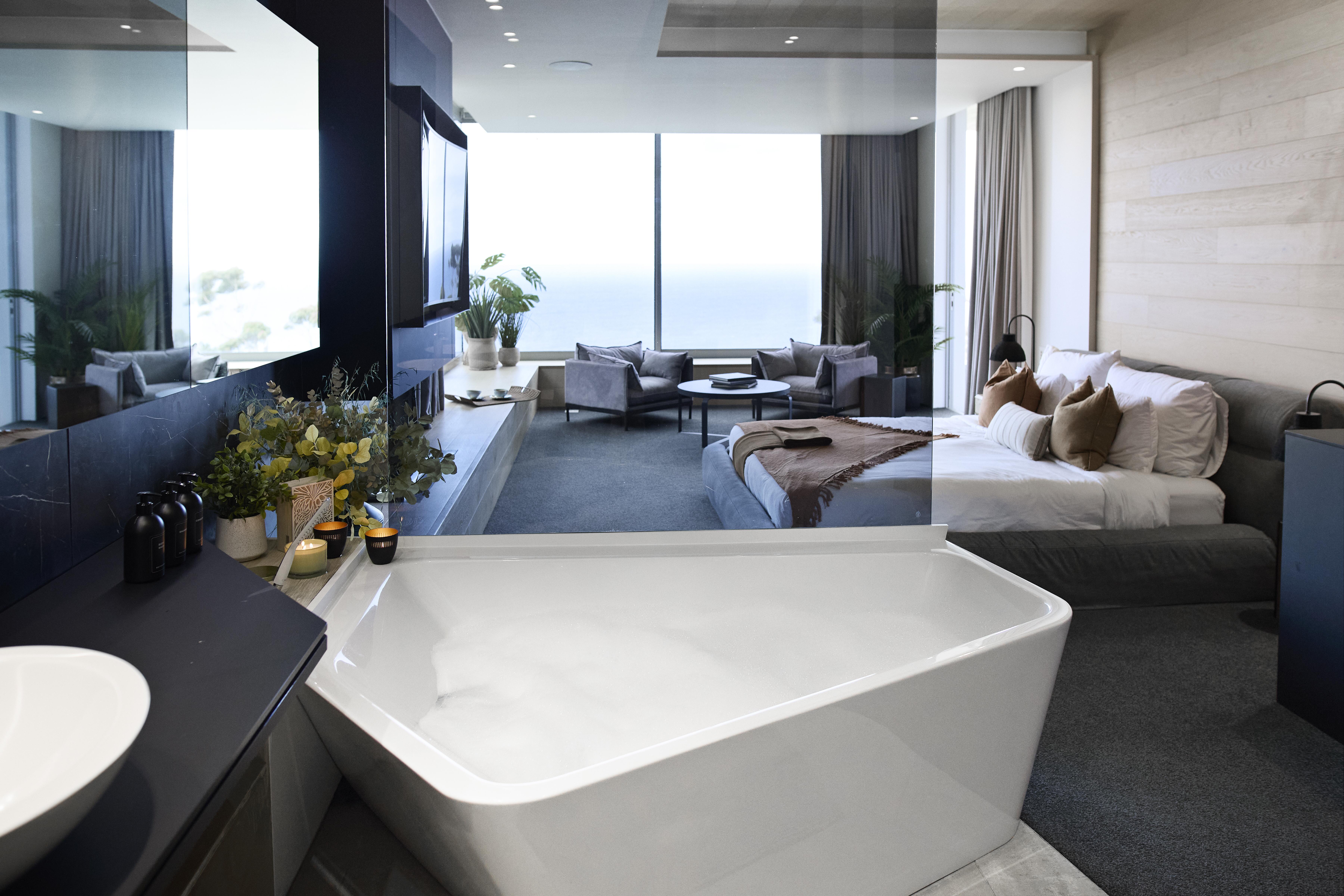 Interior of an incredibly fancy and clean modern hotel room.