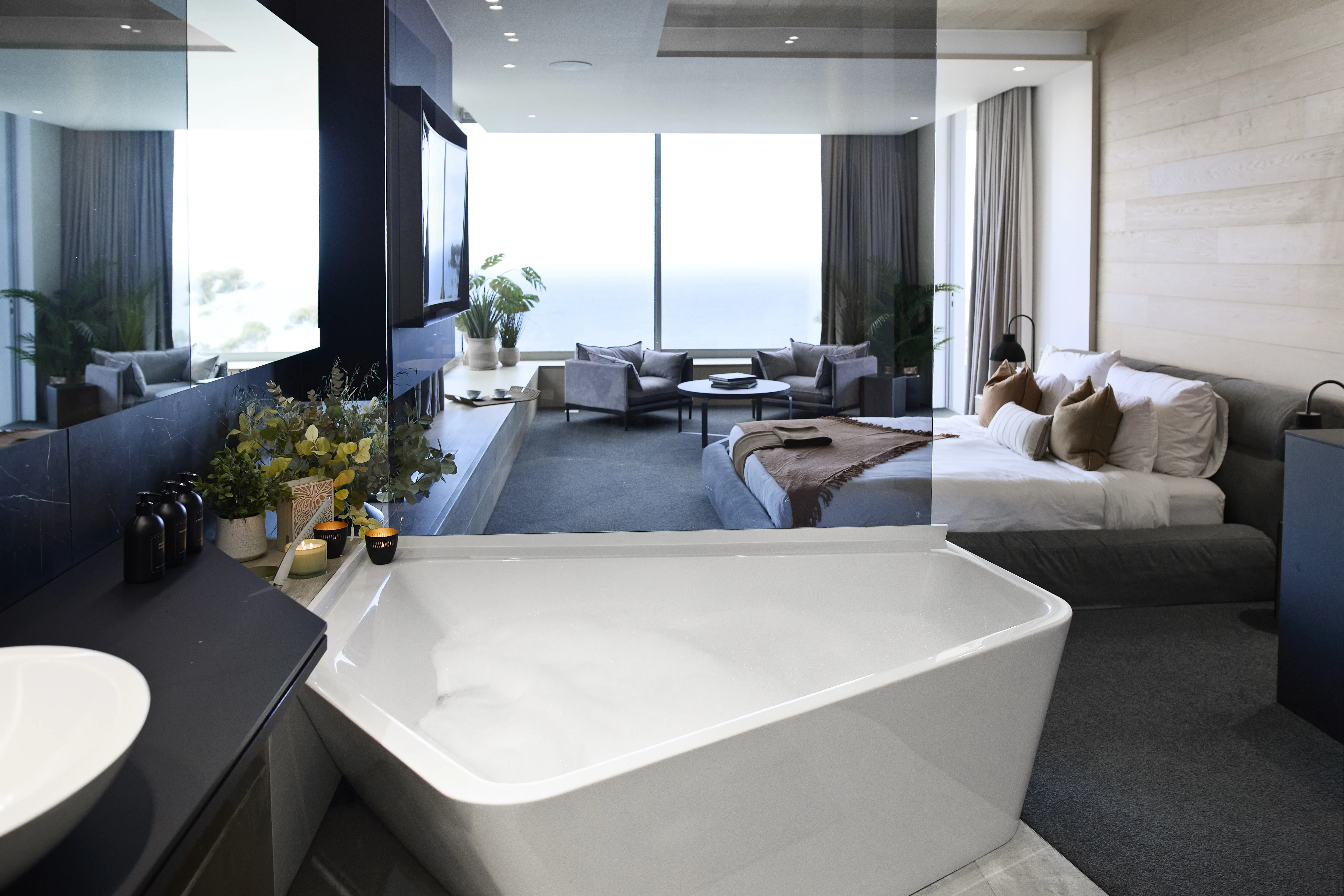 Interior of an incredibly fancy and clean modern hotel room.