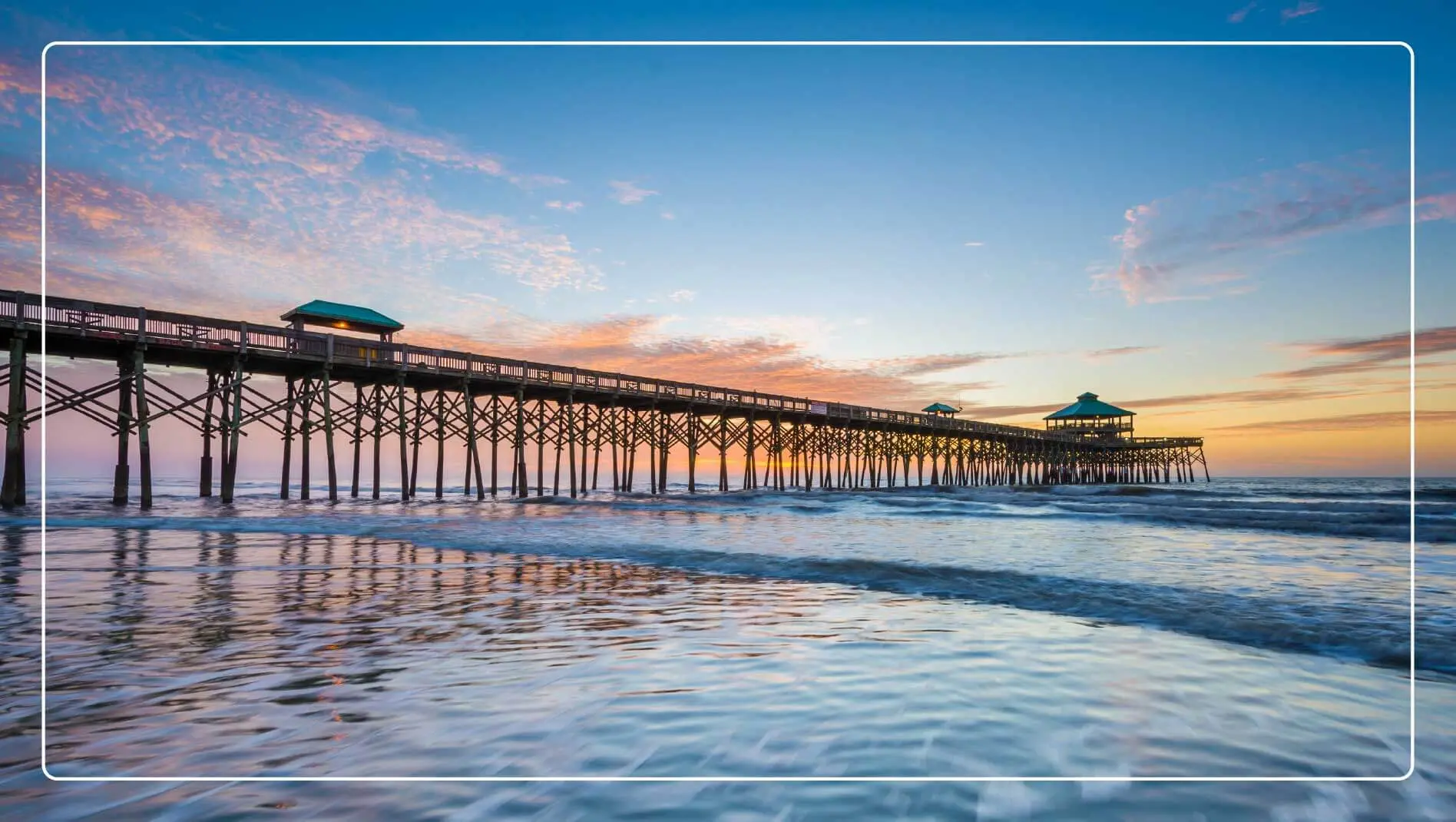 The Folly Beach pier over the water at sunrise.
