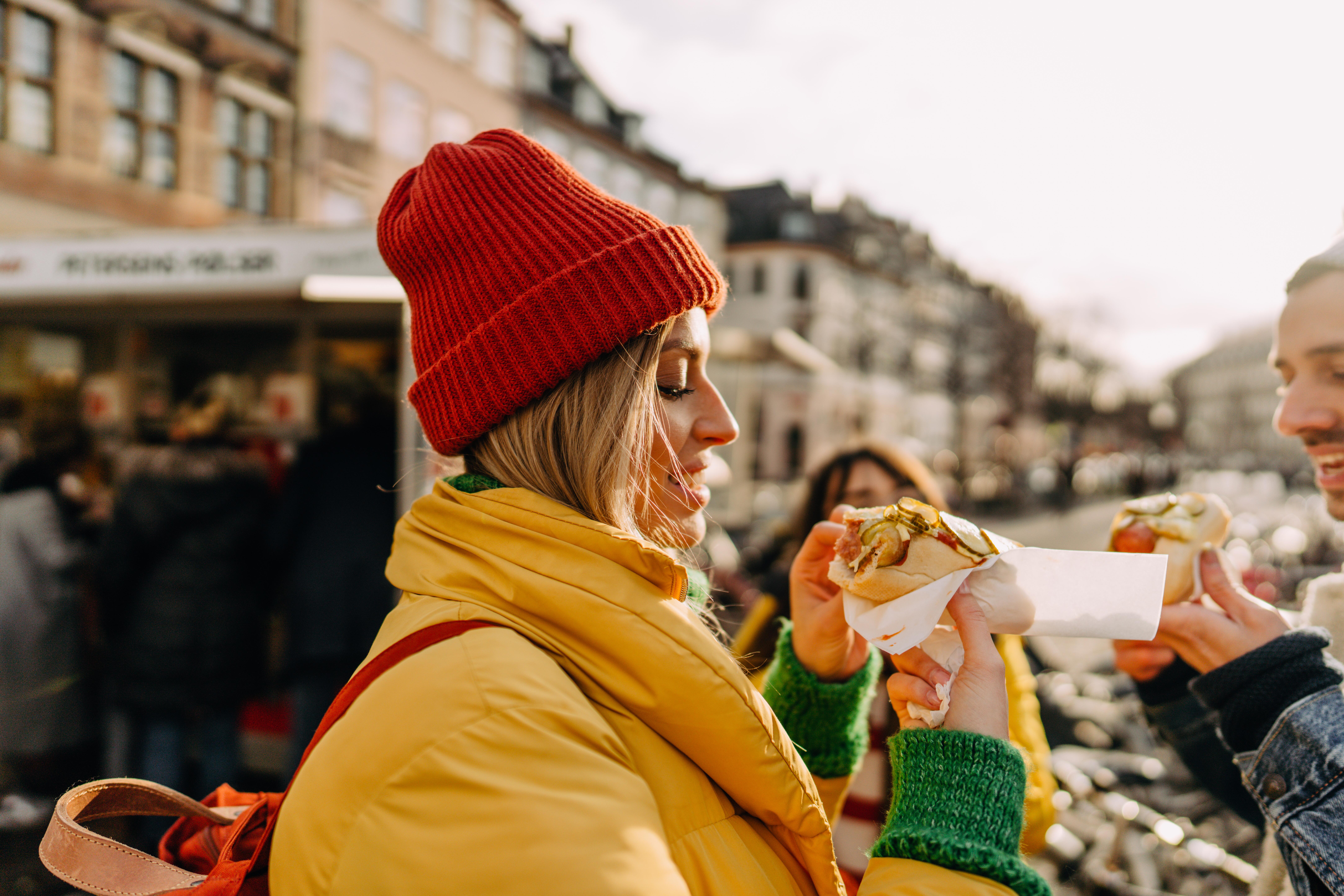 Photo of a woman eating food in Copenhagen, Denmark