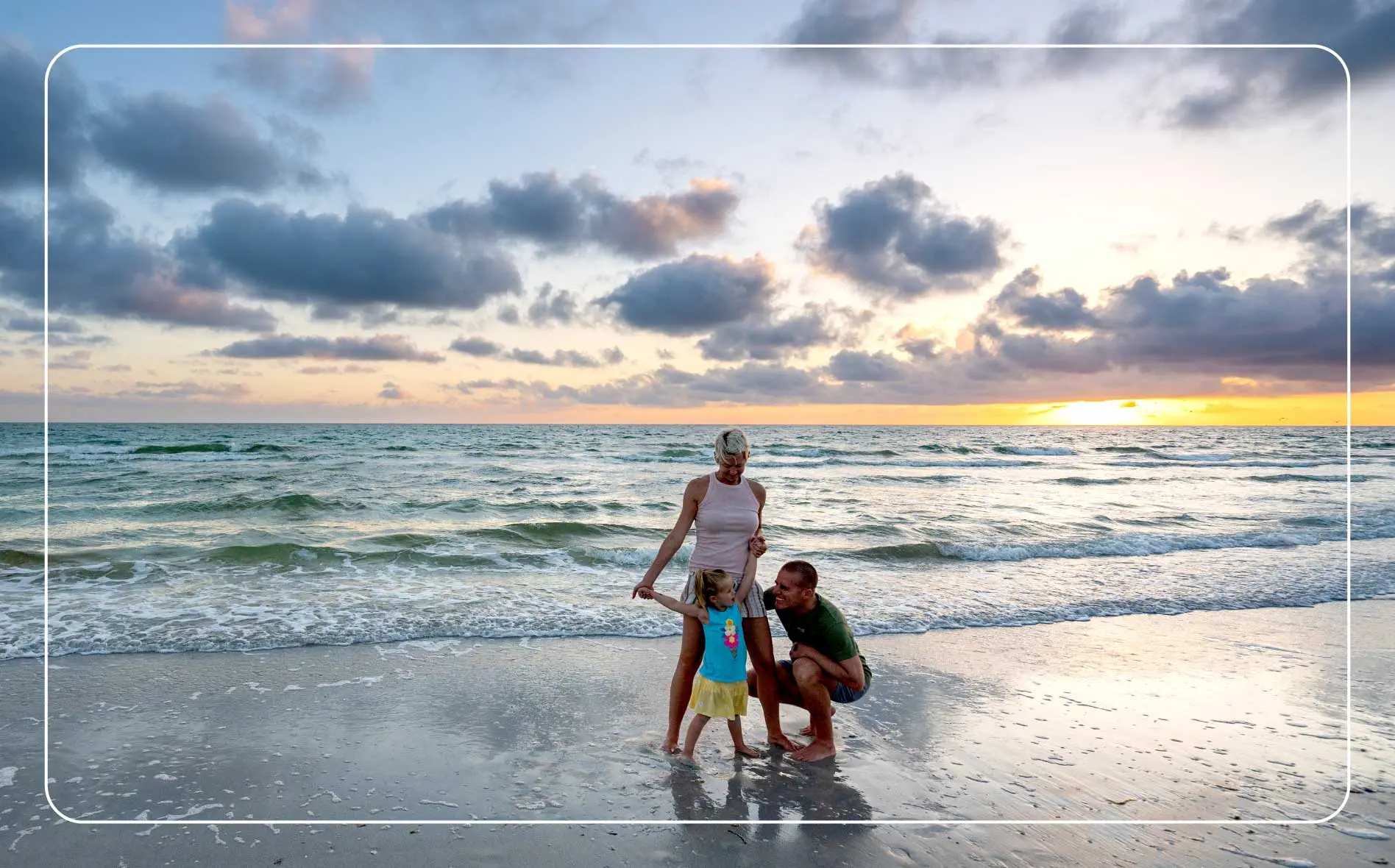 A family enjoying the beach waves at Treasure Island Beach.